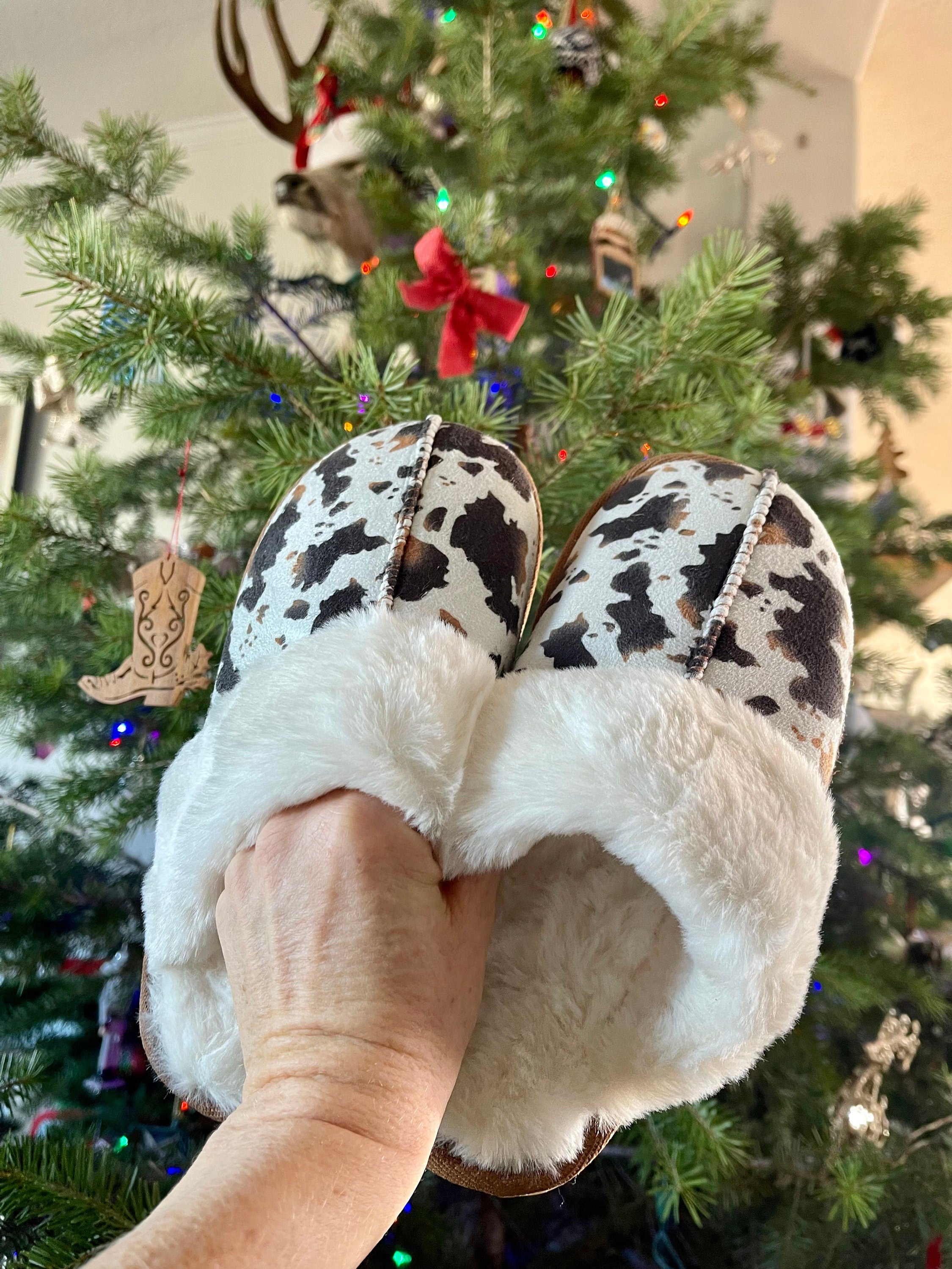 Cowprint Slippers with Plush Sherpa Lining feature a rubber sole, perfecting for trekking inside and out, and the softest plush Sherpa lining. They are so soft! The perfect house shoe!