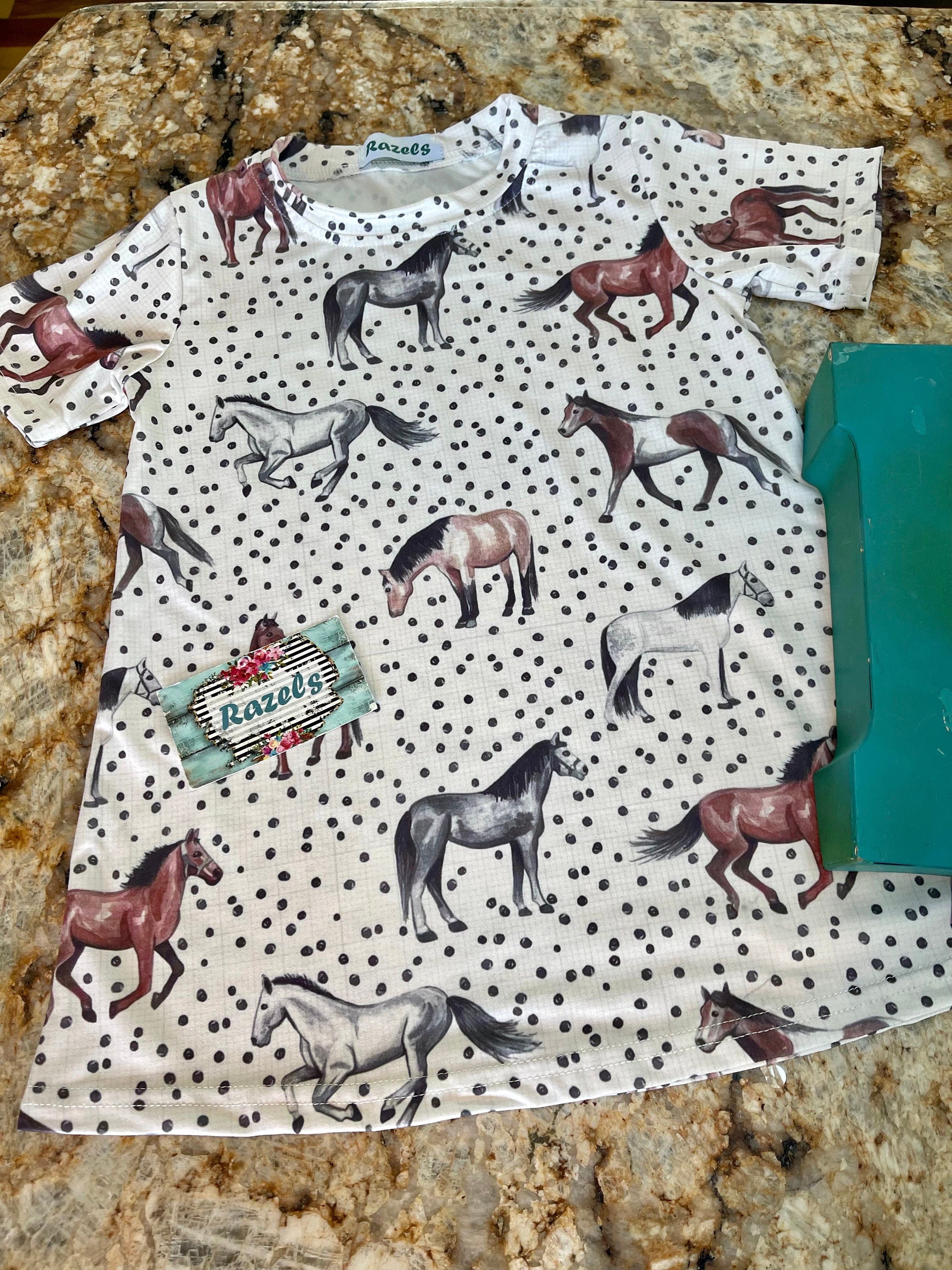 Girls&#39; Horse Dress | Horse Girl Era | Horse Girl T-Shirt Dress 🐴✨

For the little horse lover in your life, this adorable Horses T-Shirt Dress is a must-have! 🌞 Featuring a charming horse print and a playful polka dot design, this dress is perfect for every little cowgirl who lives for all things horses!

✨ Why You’ll Love It:
✔ Versatile Style: Easy to dress up or down—pair with leggings and a jean jacket for a whole new look!
✔ Comfortable Fit: Soft cotton/spandex blend for all-day com