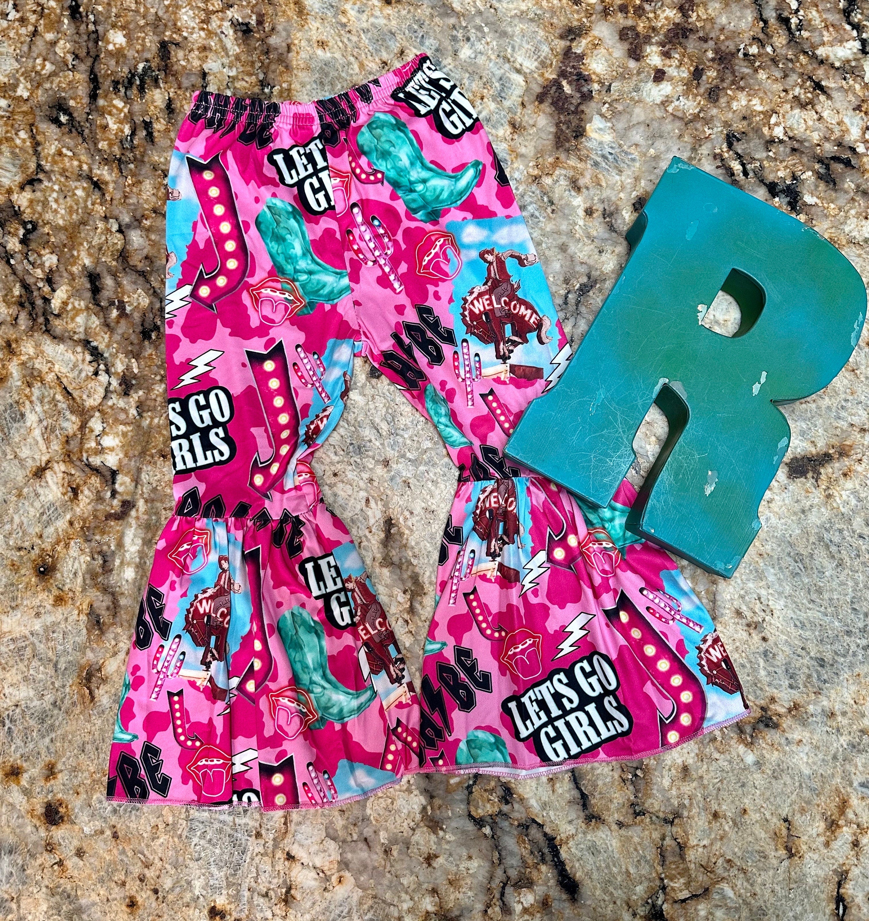 Bell bottom outfit - baseball style t-shirt with HOWDY BABE scrolled across the front and pink sleeves and pink bell bottoms with the funnest cowgirl motif - Let&#39;s go girls, bronc riders, neon signs, turquoise boots, lips and lightning bolts