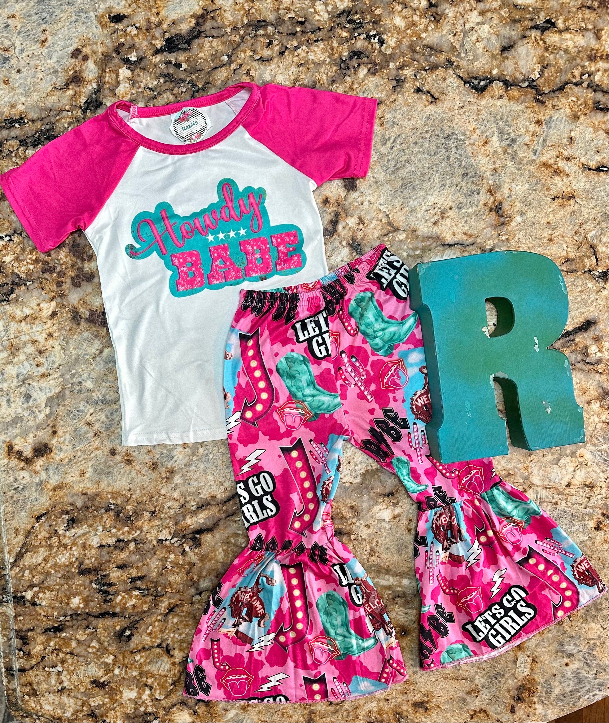 Bell bottom outfit - baseball style t-shirt with HOWDY BABE scrolled across the front and pink sleeves and pink bell bottoms with the funnest cowgirl motif - Let&#39;s go girls, bronc riders, neon signs, turquoise boots, lips and lightning bolts