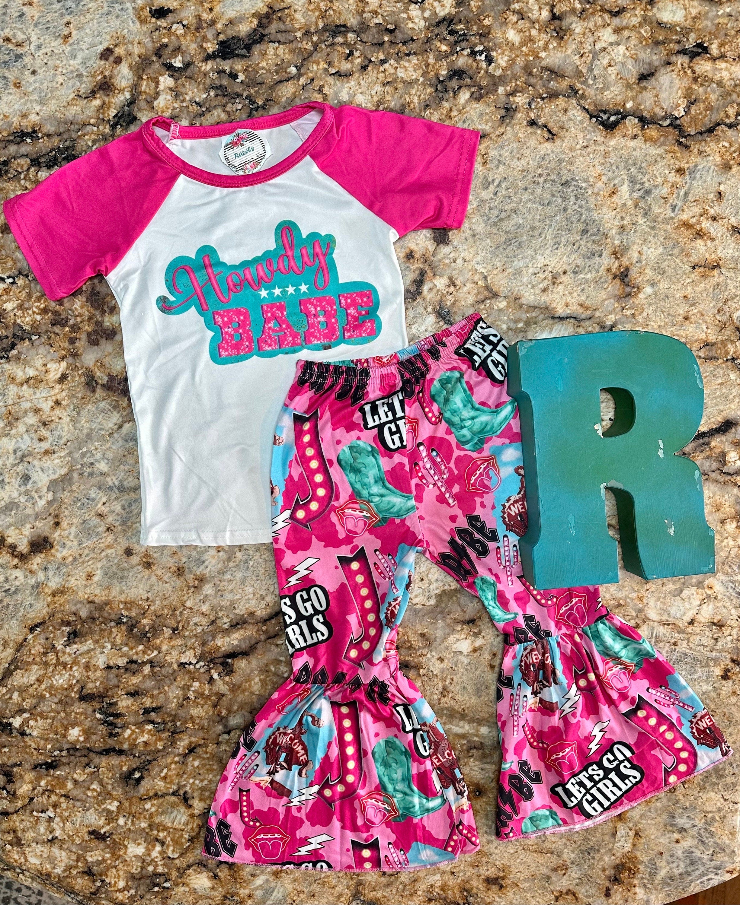 Bell bottom outfit - baseball style t-shirt with HOWDY BABE scrolled across the front and pink sleeves and pink bell bottoms with the funnest cowgirl motif - Let&#39;s go girls, bronc riders, neon signs, turquoise boots, lips and lightning bolts