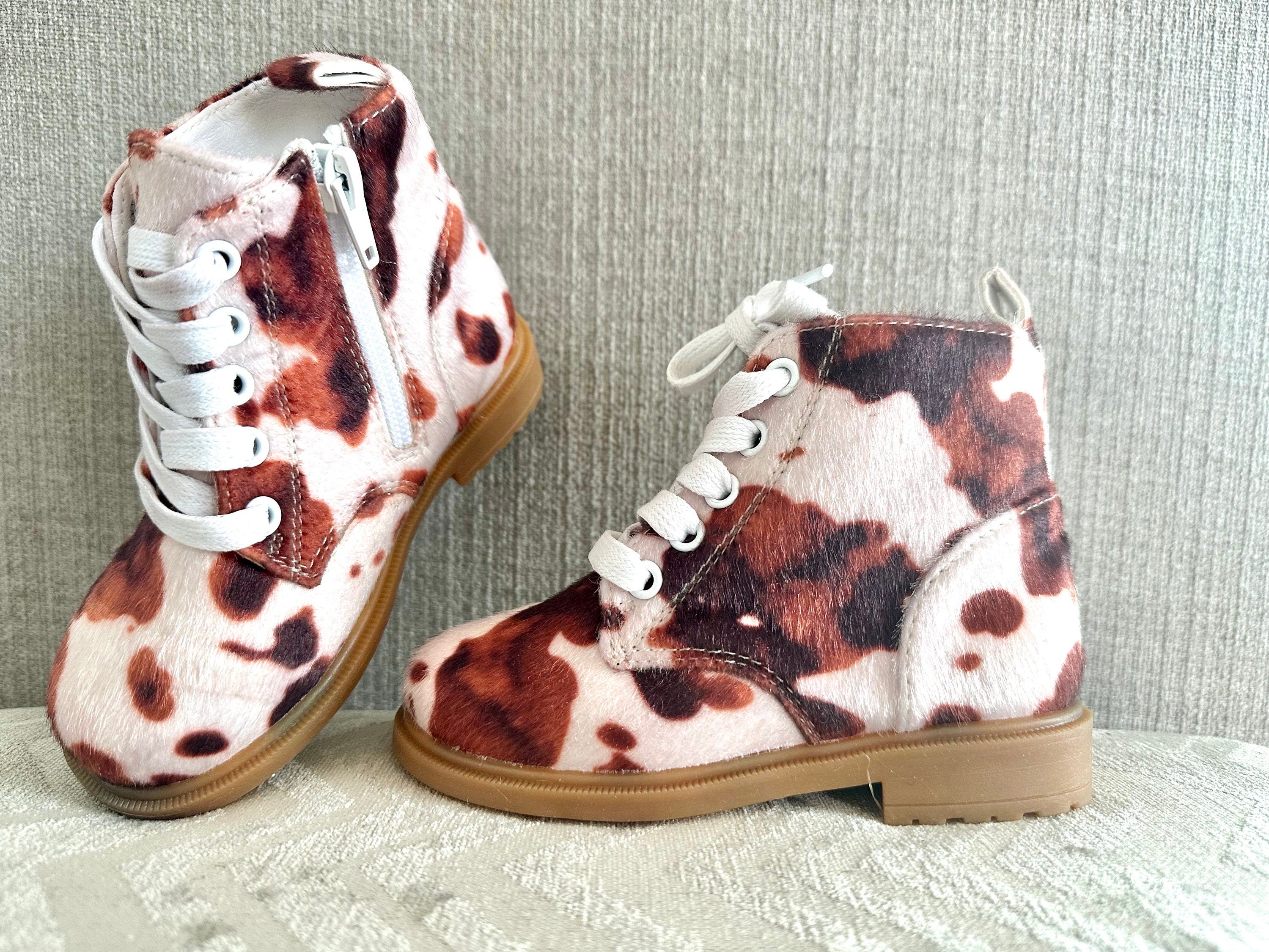 Cow Print Boots for Toddlers 🤎🤍 Yeehaw! These adorable cowprint boots are the ultimate statement piece for your little cowgirl or cowboy. Whether you&#39;re headed to the rodeo, school, or the playground, these toddler Western boots add a whole lot of charm to every step!  ✔️ Fun & stylish brown cow print ✔️ Side zippers for easy on & off ✔️ Durable rubber sole + comfy cotton/leather blend ✔️ Perfect for dressing up or down ✔️ Great for rodeos, family photos, fall fairs & more!