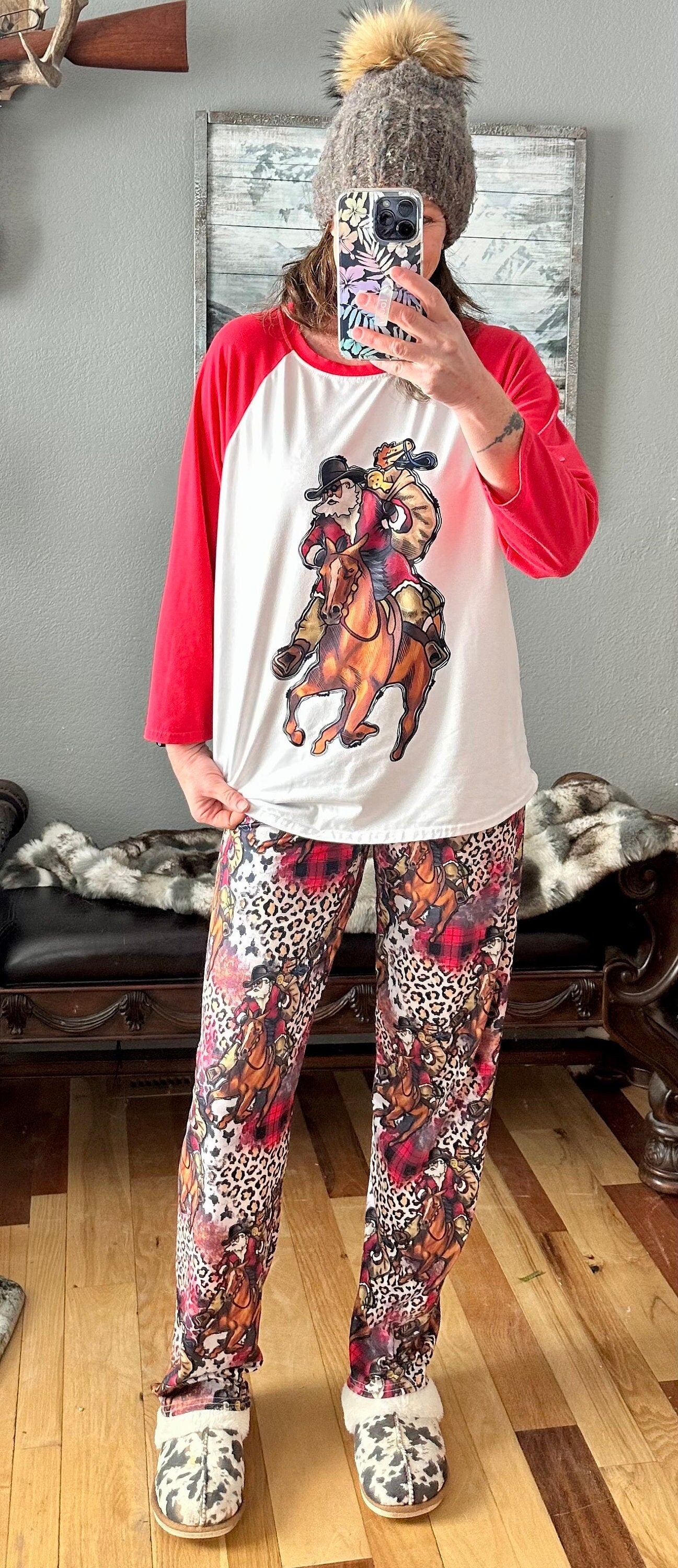 Cowboy Christmas Horse Family PJs with baseball t-shirt featuring Cowboy Santa delivering packages on his best horse, and Santa Jingle horse and cheetah print cover the comfy lounge pants. Cowprint Slippers are also available.