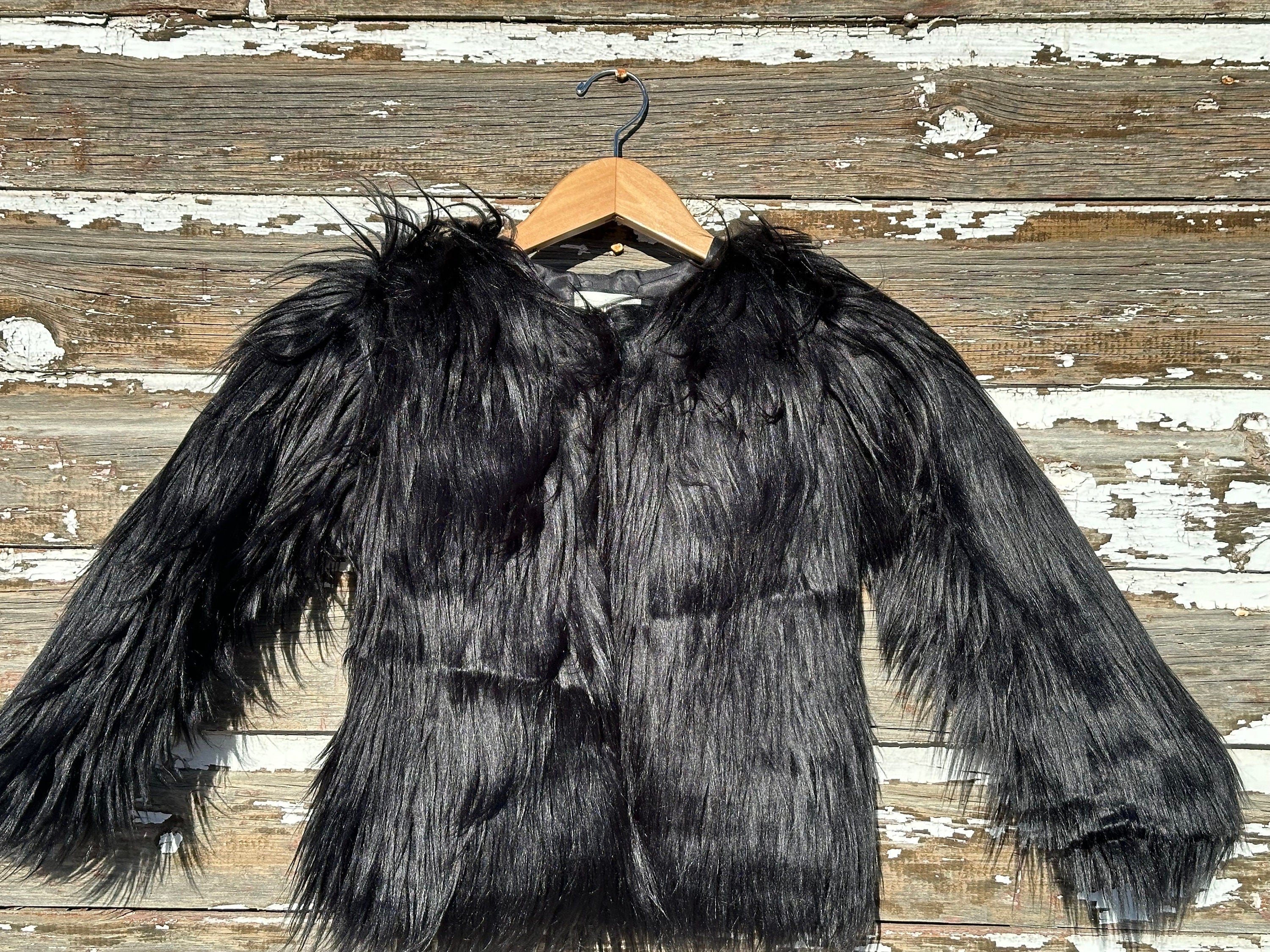 Girls fur coat features a fabulous shaggy fur exterior, silky smooth lining, and convenient eye and hook closures. She’ll feel and look like a princess in this stunning coat from Razels.