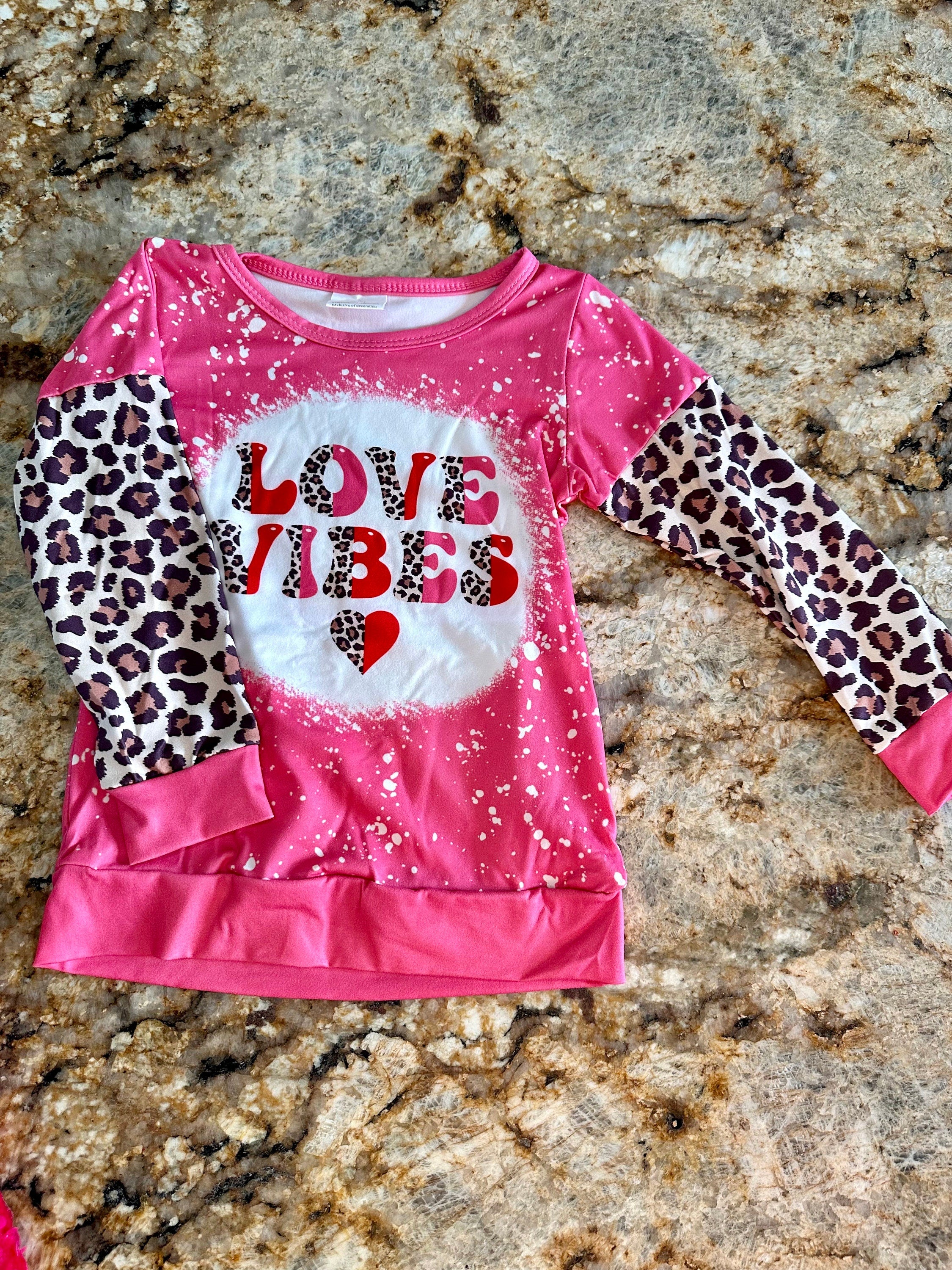 Girls Love Vibes Shirt with animal print sleeves.