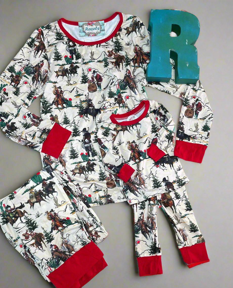 Cowboy Santa Christmas pajamas feature Cowboy Santa delivering packages on his trusty horse, riding among the trees and mountains. The cuffs of the long-sleeve top and pajama pants, as well as the neckline, are red.