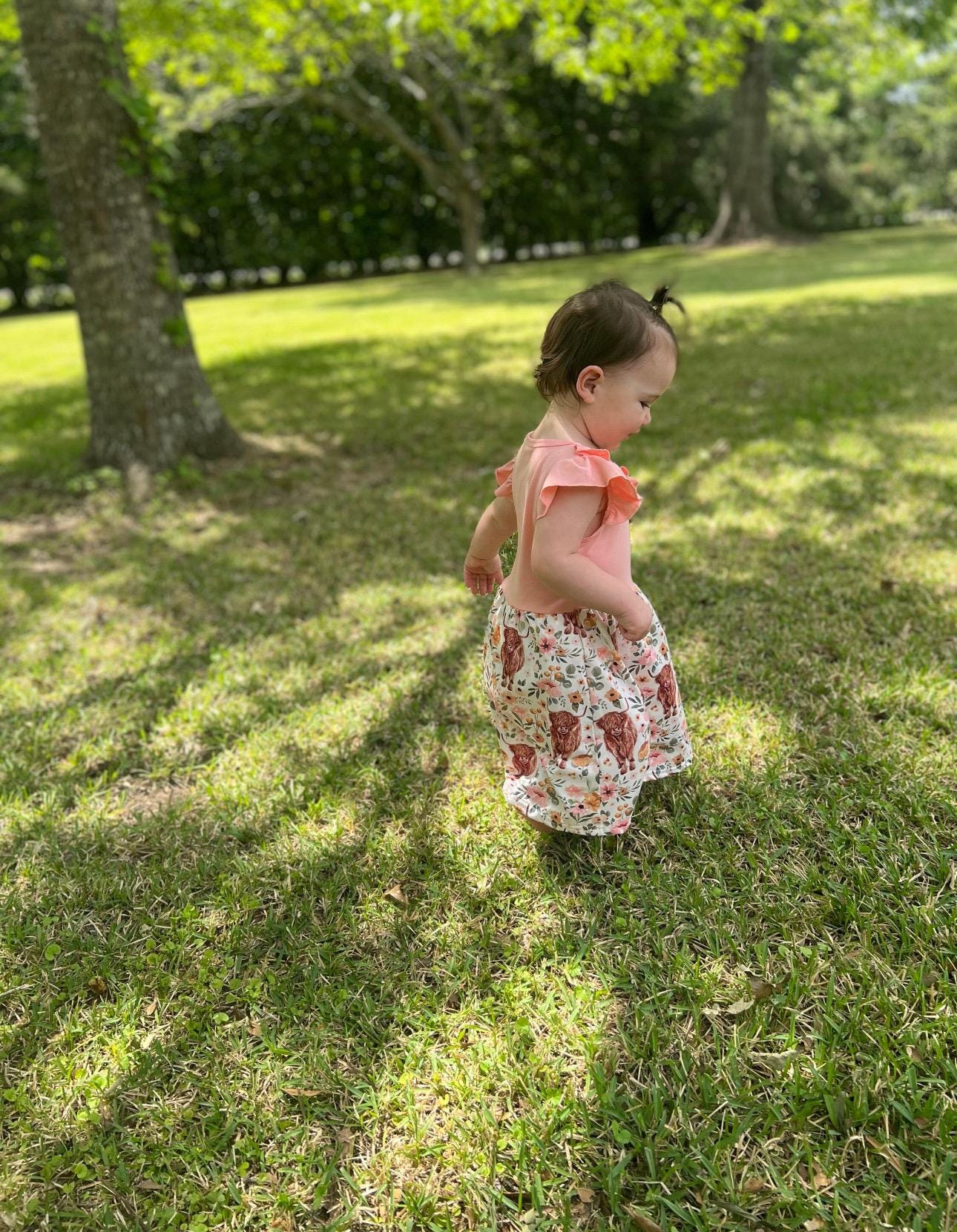 Scottish Highland Cow Dress! 🐄💖 It&#39;s the perfect blend of comfort and style, featuring a cute floral highlander cow print on the bottom. The soft top has flutter sleeves, a collar, and button details for an added touch of charm. Ships FREE with $35
