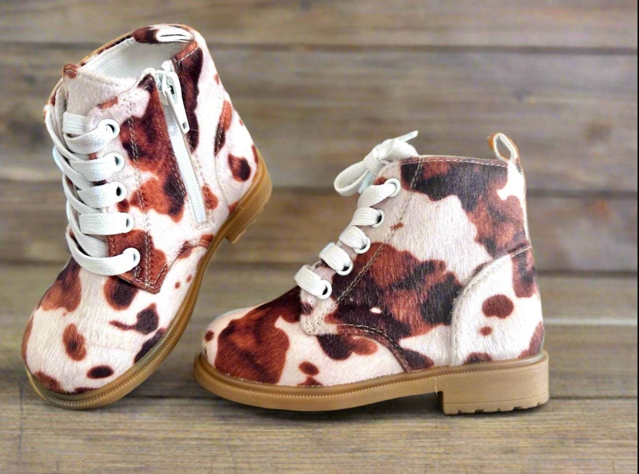 Cow Print Boots for Toddlers 🤎🤍 Yeehaw! These adorable cowprint boots are the ultimate statement piece for your little cowgirl or cowboy. Whether you&#39;re headed to the rodeo, school, or the playground, these toddler Western boots add a whole lot of charm to every step!  ✔️ Fun & stylish brown cow print ✔️ Side zippers for easy on & off ✔️ Durable rubber sole + comfy cotton/leather blend ✔️ Perfect for dressing up or down ✔️ Great for rodeos, family photos, fall fairs & more!