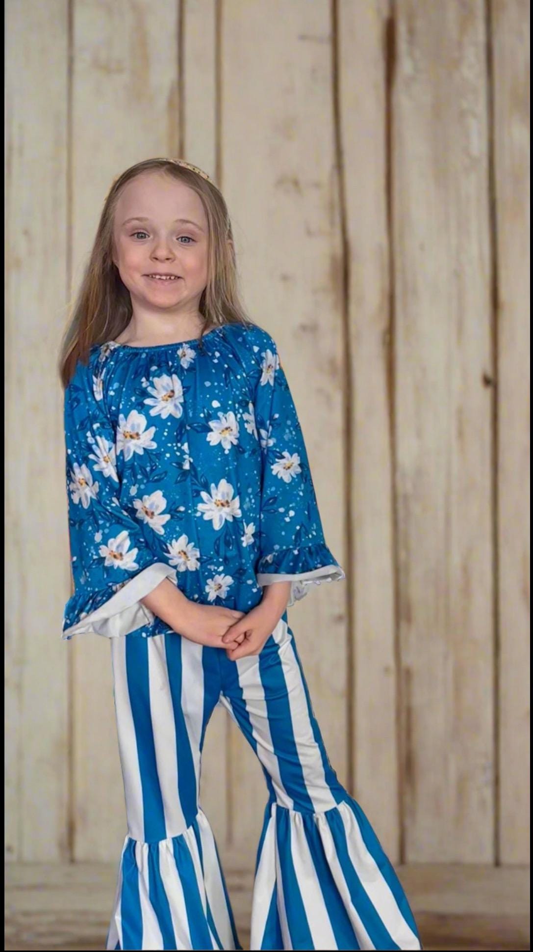 Daisy Blouse & Blue & White Striped Bell Bottom Pants Outfit is a perfect pick for SPRING ✔ Eye-catching Design: Blouse features a white daisy print on a blue blouse. The coordinating blue-and-white striped bell-bottom pants add flair to the outfit.