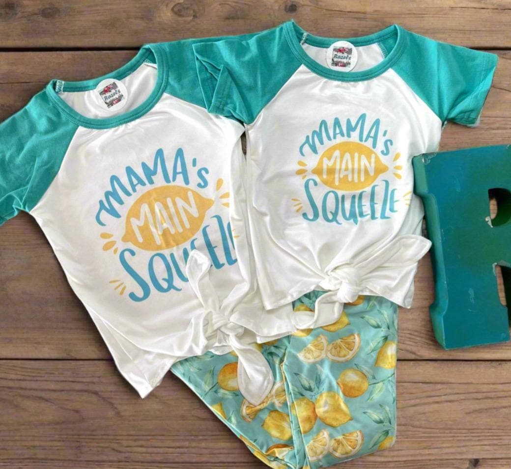 🍋 Mama&#39;s Main Squeeze Bell Bottom Outfit - a cheerful lemon-themed outfit! This adorable set features a playful &quot;Mama&#39;s Main Squeeze&quot; t-shirt and bell bottoms with an all over lemon print, adding a burst of sunshine to any day.