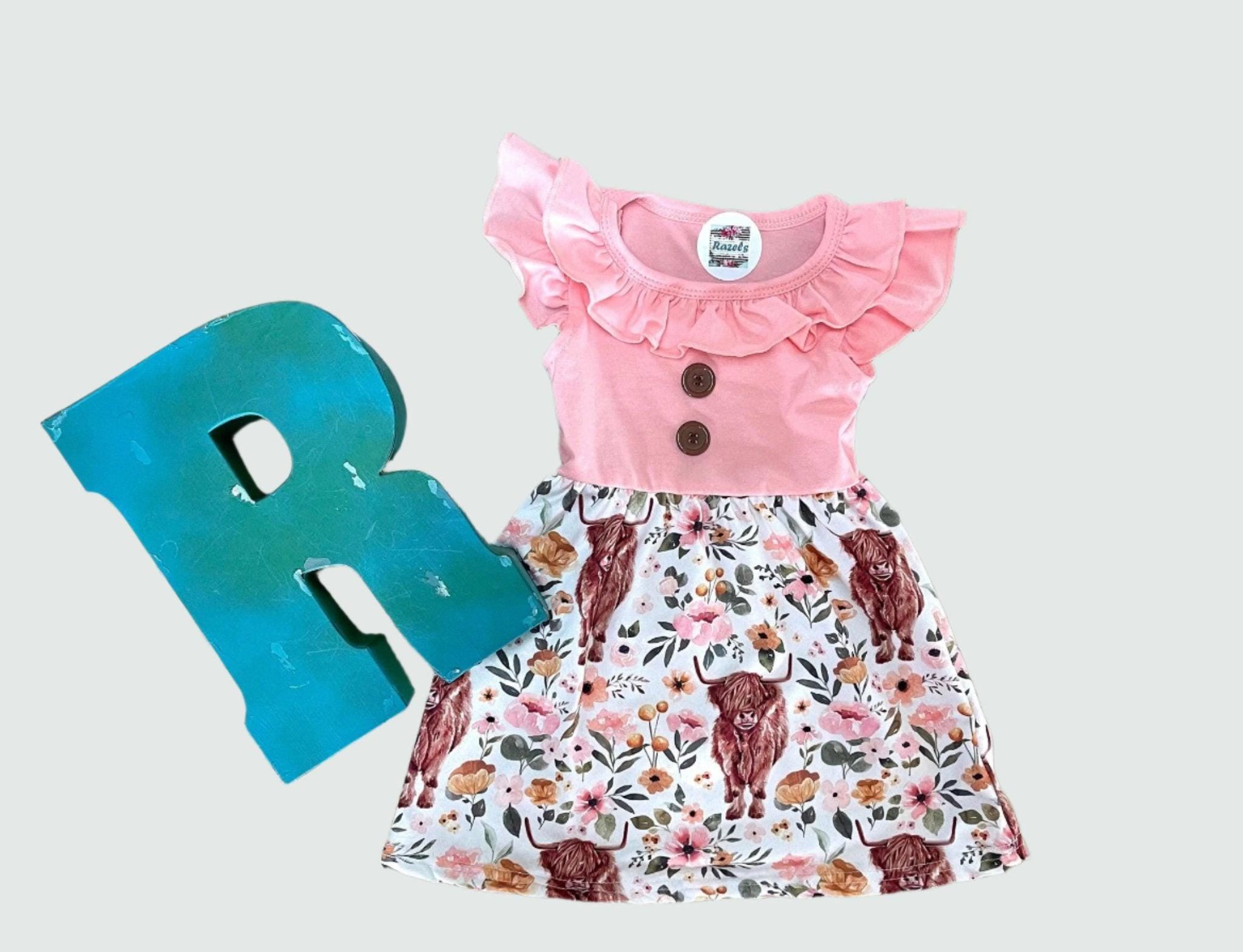 Scottish Highland Cow Dress! 🐄💖 It&#39;s the perfect blend of comfort and style, featuring a cute floral highlander cow print on the bottom. The soft top has flutter sleeves, a collar, and button details for an added touch of charm. Ships FREE with $35