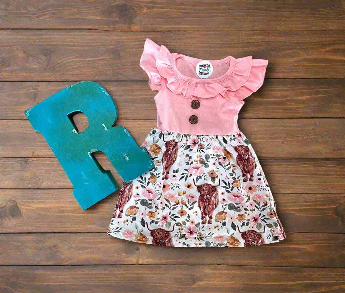 Scottish Highland Cow Dress! 🐄💖 It&#39;s the perfect blend of comfort and style, featuring a cute floral highlander cow print on the bottom. The soft top has flutter sleeves, a collar, and button details for an added touch of charm. Ships FREE with $35