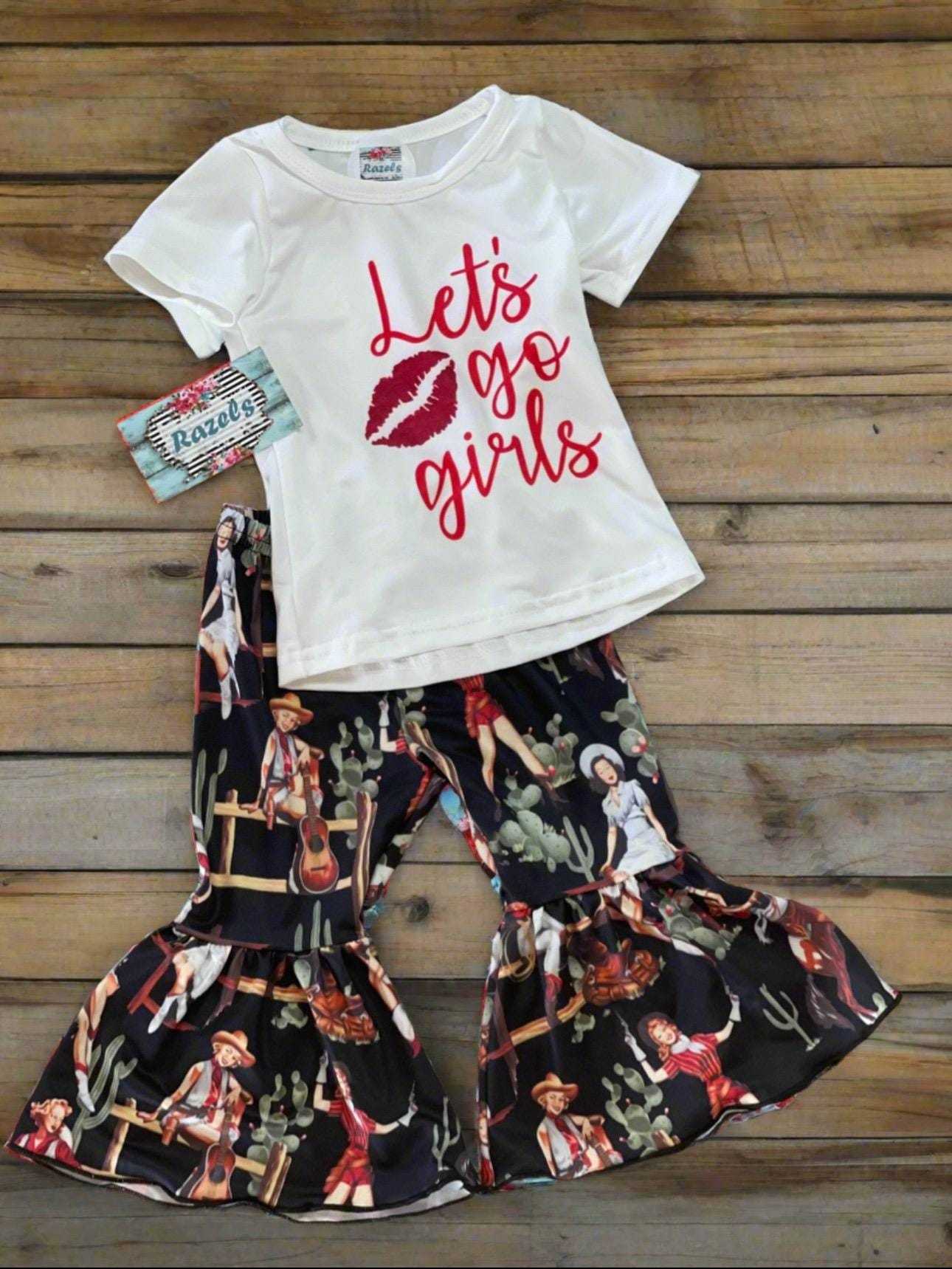 Let’s Go Girls! 💖 This adorable Western outfit is made for your bold little cowgirl! Whether you pick the bell bottoms or the short set, she’ll be ready to twirl, dance, and shine at concerts, rodeos, or just struttin’ into preschool like she owns the place. 

🎤 Limited sizes left — just $15 each while they last!

✓ Soft & stretchy cotton/spandex blend
✓ Choose between flared bell bottoms or cute shorts
✓ Trendy “Let’s Go Girls” tee in a soft, lived-in feel