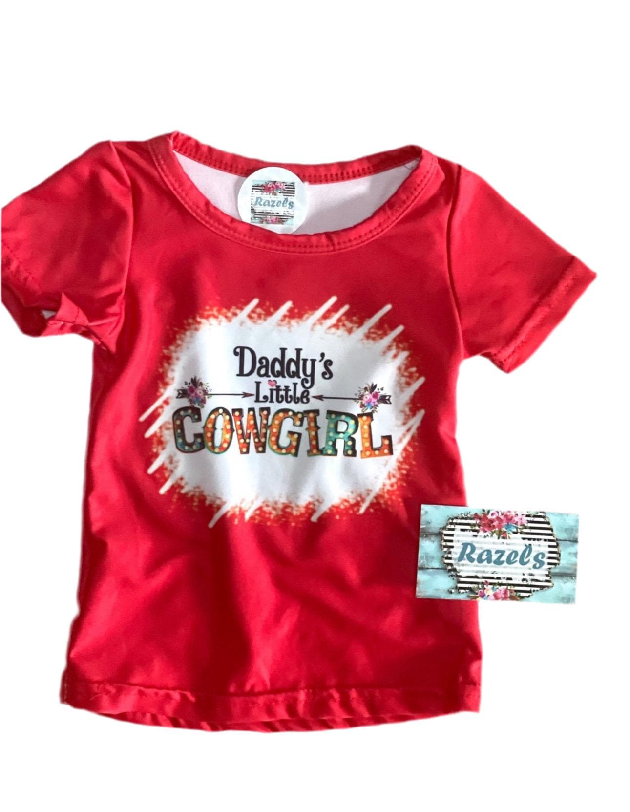 Daddy’s Little Cowgirl Bell Bottom Outfit perfect for Father&#39;s day and all Spring long! This Girls Western T-Shirt & Flower Bell Bottom Pants Set features a red &#39;Daddy&#39;s Little Cowgirl&#39; graphic T-shirt paired with vibrant flower pants bell-bottom style! Ships FREE with $35+ purchase