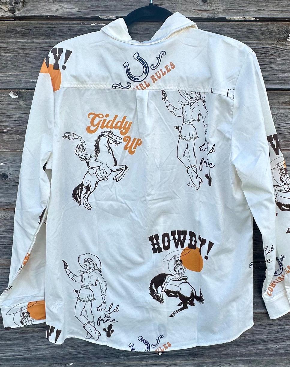 Women&#39;s off-white long-sleeved Western button-up shirt featuring &#39;Cowgirl Rules,&#39; roping cowgirls, howdy text, and horseshoes. Perfect Fall blouse for layering with jeggings and other seasonal styles