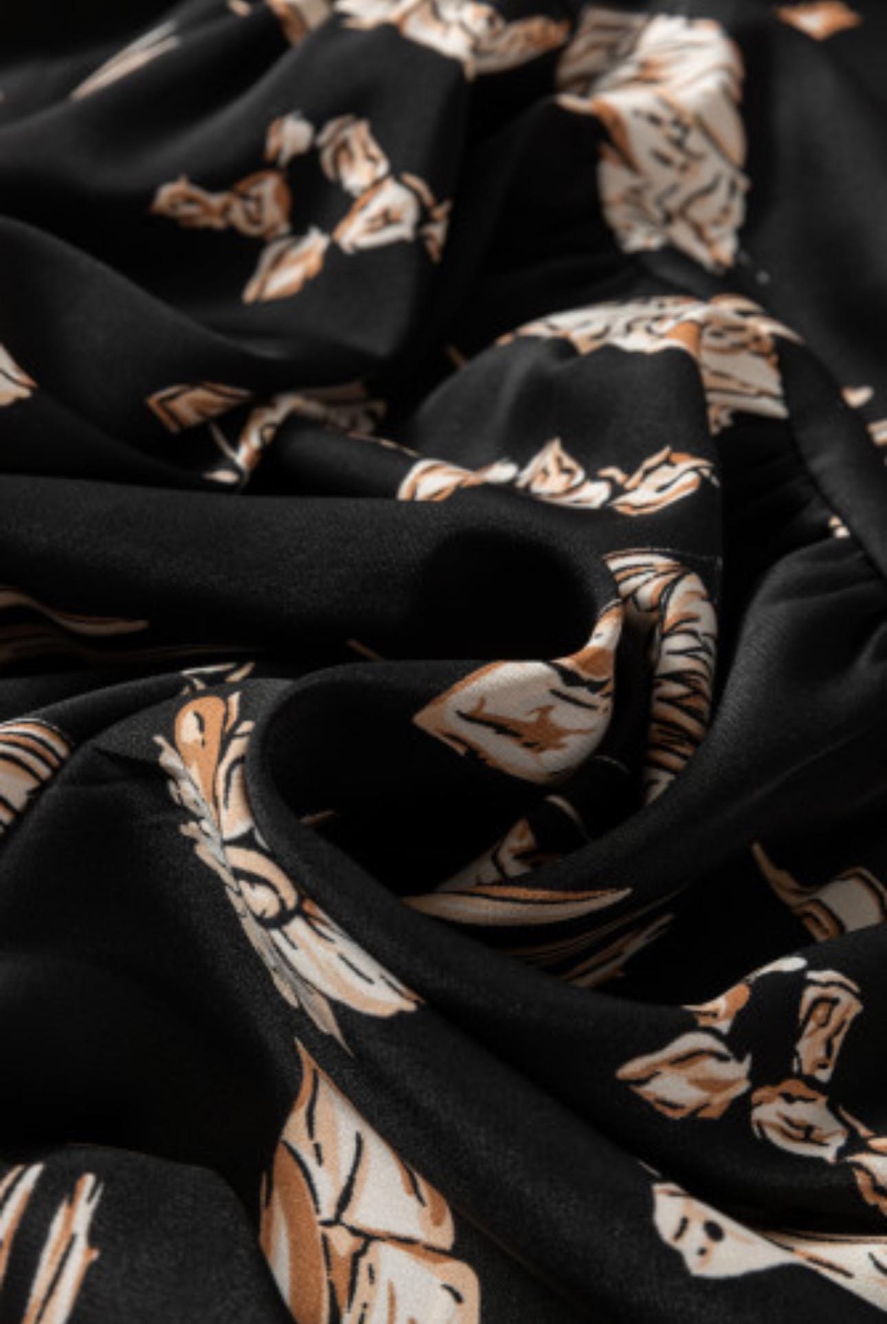 Women&#39;s Western BOHO maxi skirt features a charming western print with horses, cacti, flowers, and cowboy hats. It has a high-waisted design and a flowing silhouette in a fall color combo of black, brown, tan, and cream.