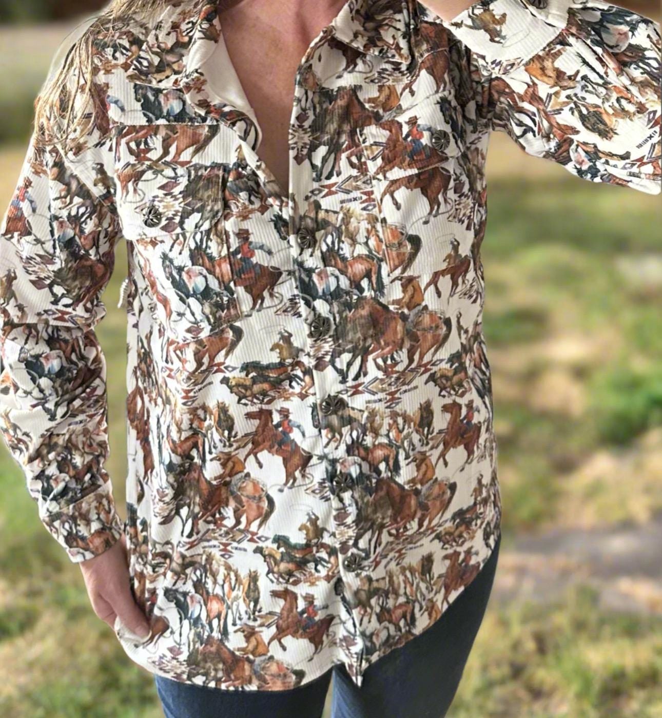 The Fall Cowgirl Button-Up Corduroy Shirt! This Western-inspired shirt features a stylish Cowboy Print in shades of brown, cream, and green, ideal for the fall season. The cozy corduroy fabric will keep you warm as the weather gets cooler.