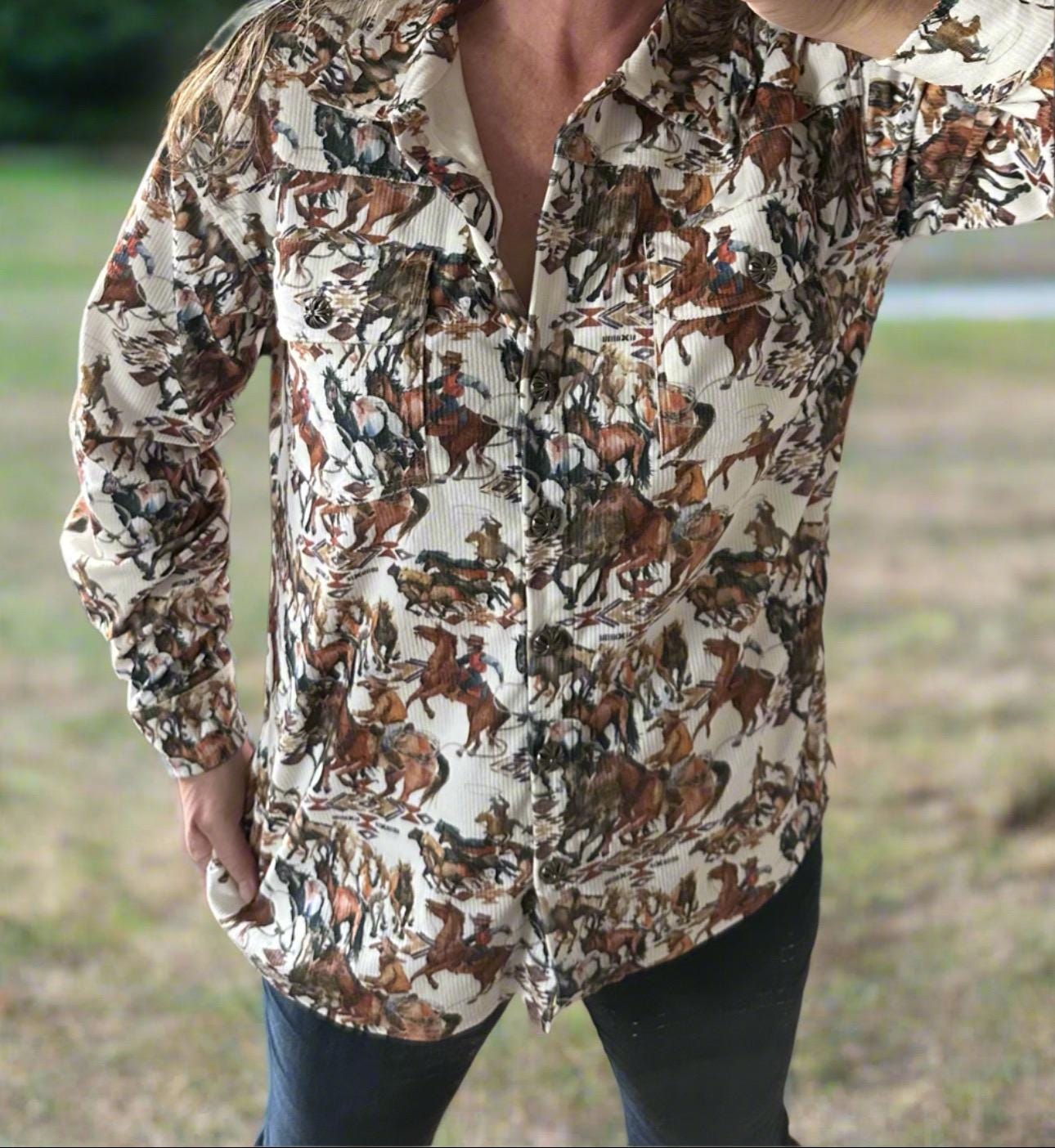 The Fall Cowgirl Button-Up Corduroy Shirt! This Western-inspired shirt features a stylish Cowboy Print in shades of brown, cream, and green, ideal for the fall season. The cozy corduroy fabric will keep you warm as the weather gets cooler.