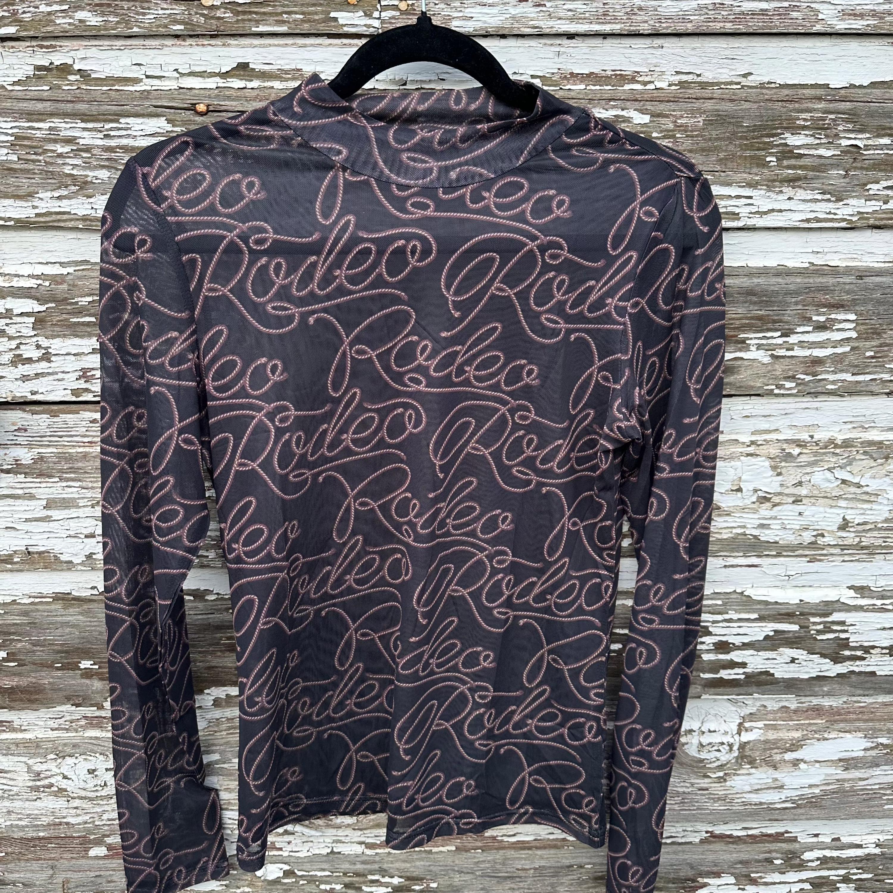 Turn heads with this Rodeo Black Mesh Western Shirt! Featuring sheer, breathable mesh and bold RODEO print, this Cowgirl Shirt is perfect for layering or rocking solo. A must-have Women’s Western Layering Sheer Shirt for rodeo nights or casual style!