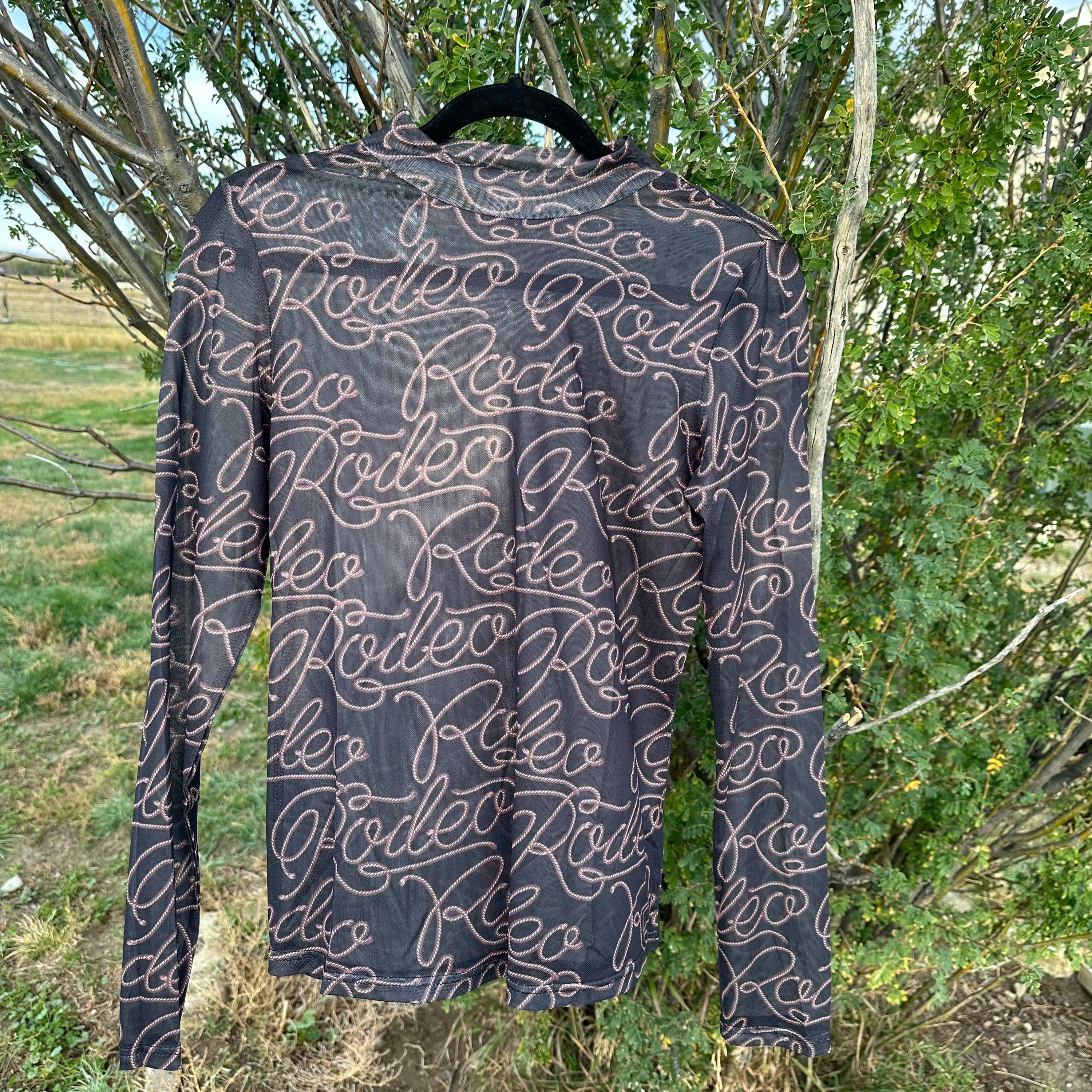 Rodeo Black Mesh Western Shirt for women, featuring breathable mesh fabric and a bold rodeo print. Long sleeves provide sun protection and comfort, making it perfect for layering or wearing alone. Ideal for stylish cowgirls on the go.