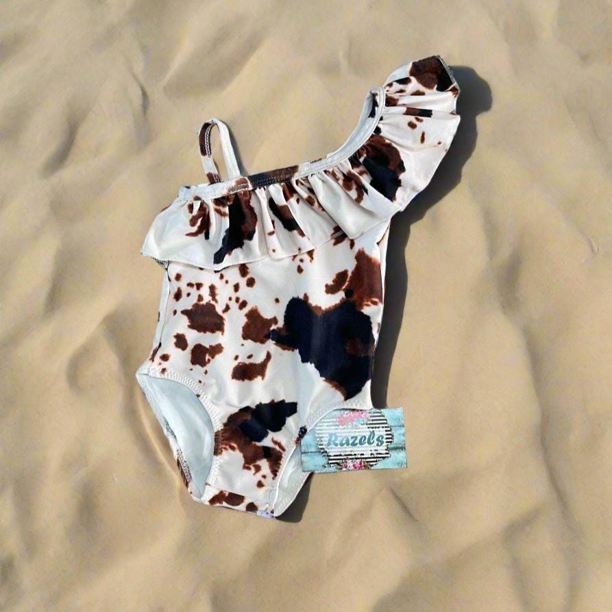 Cow Print Swim Suits are perfect for little cowboys and cowgirls!  Available Styles: Cow Print One-Piece, 2-piece tankini, or boys&#39; Cowprint Shorts.Available in sizes 0-3 months to 8/9 years. Ship FREE with $35+ purchase.