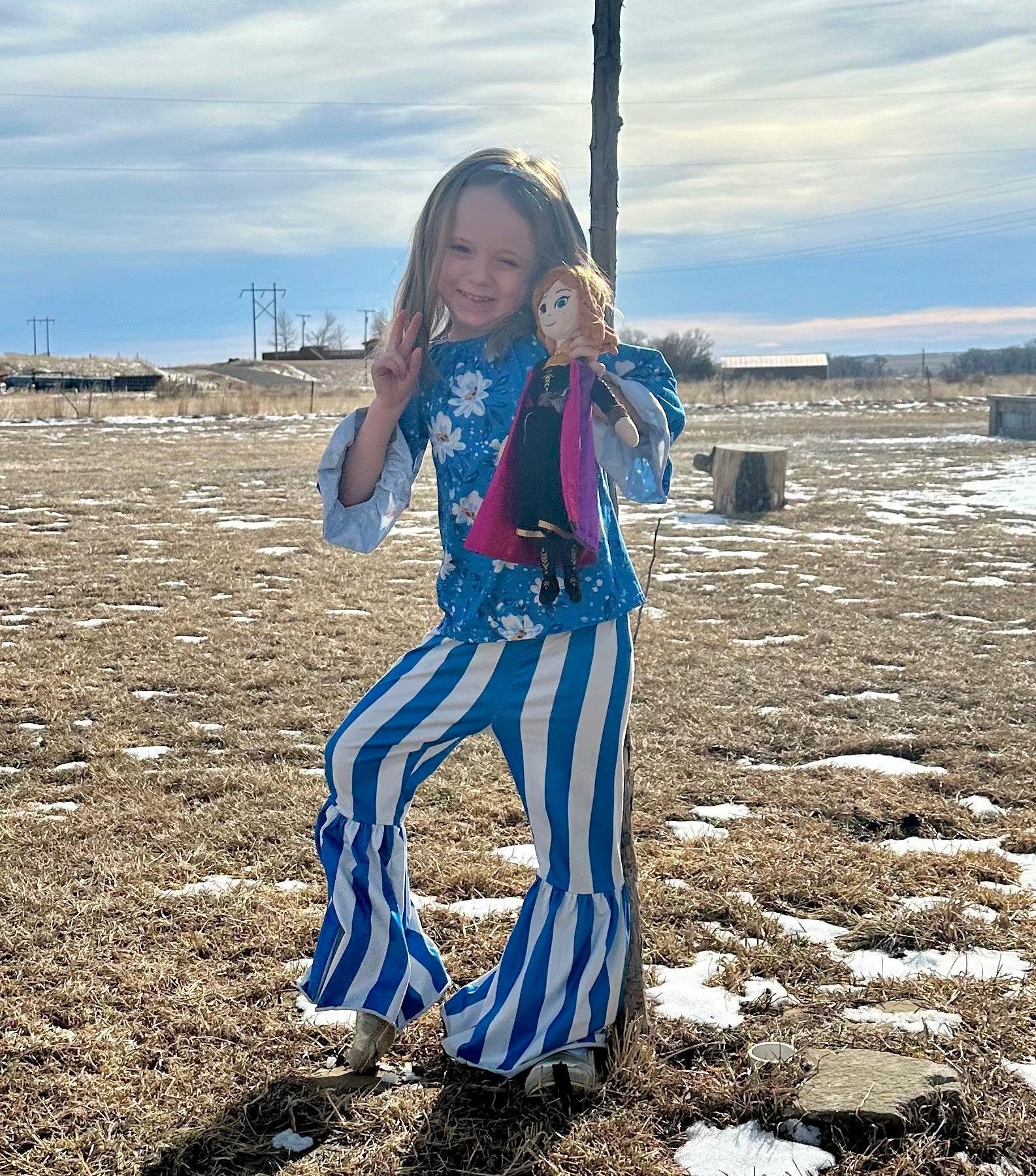 Daisy Blouse & Blue & White Striped Bell Bottom Pants Outfit is a perfect pick for SPRING ✔ Eye-catching Design: Blouse features a white daisy print on a blue blouse. The coordinating blue-and-white striped bell-bottom pants add flair to the outfit.