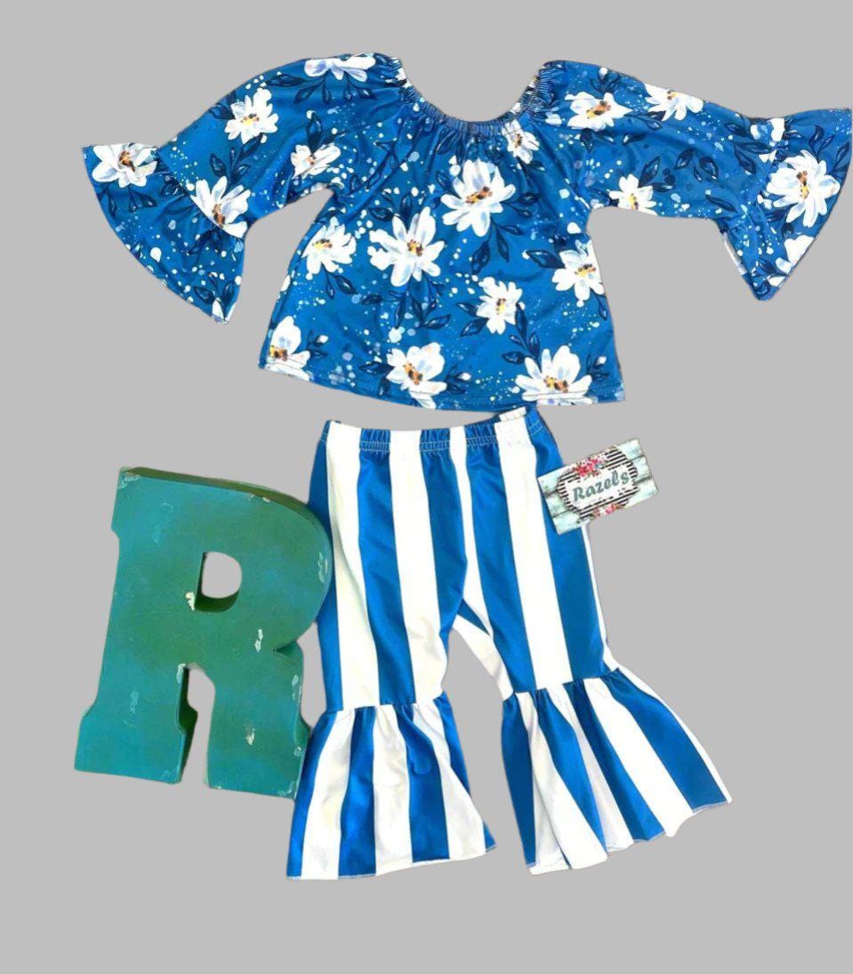 Daisy Blouse & Blue & White Striped Bell Bottom Pants Outfit is a perfect pick for SPRING ✔ Eye-catching Design: Blouse features a white daisy print on a blue blouse. The coordinating blue-and-white striped bell-bottom pants add flair to the outfit.