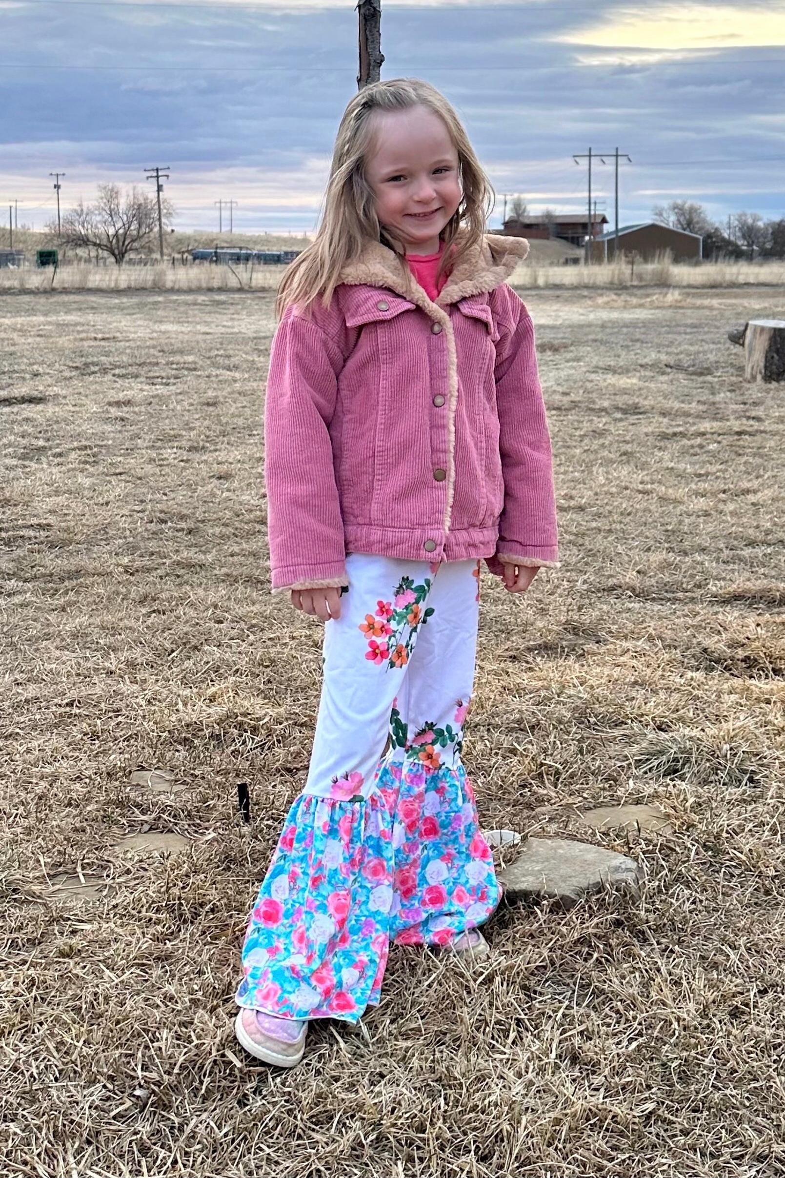 Floral Bell Bottoms designed with vibrant flower patterns and fun, playful colors are made with high-quality materials that promise comfort and durability, ensuring they’ll be a favorite all season long. These Wildflower pants will not disappoint!