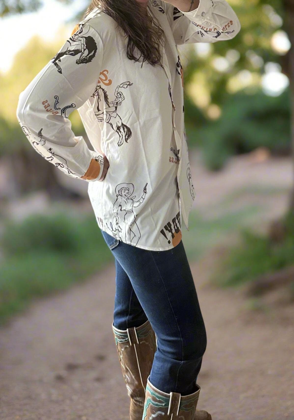 Women&#39;s off-white long-sleeved Western button-up shirt featuring &#39;Cowgirl Rules,&#39; roping cowgirls, howdy text, and horseshoes. Perfect Fall blouse for layering with jeggings and other seasonal styles