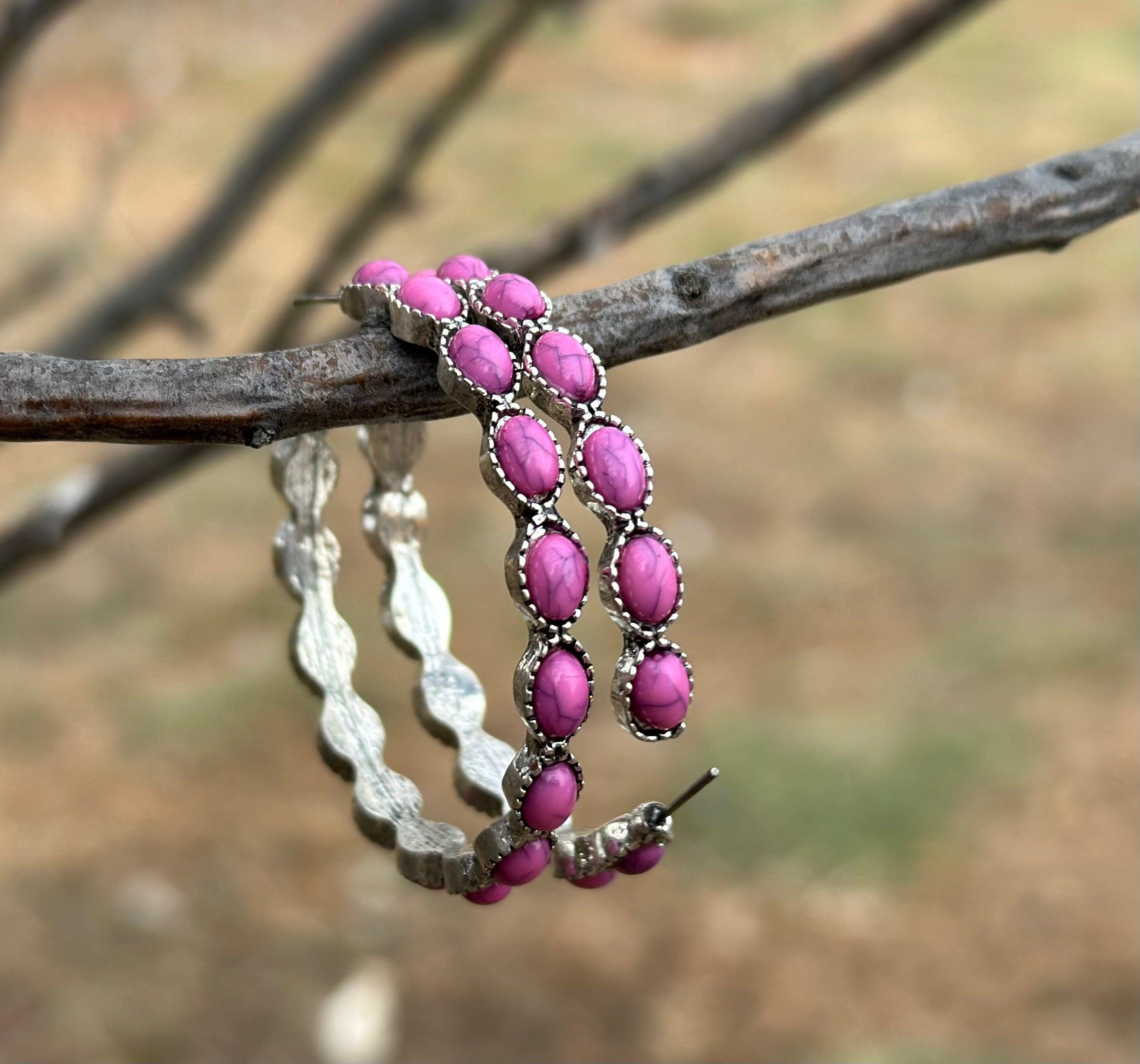 Pink Stone Hoop Earrings 🩷 

Make a bold statement with our Pink Stone Hoop Earrings—the perfect accessory for any cowgirl or Southwestern style lover! 🌟 These large Western earrings are crafted in a stylish C-shape design, featuring vibrant pink gemstones and a burnished silver finish that blends rustic charm with timeless elegance.
These earrings aren’t just accessories—they’re must-have pieces for anyone who loves boho-chic or Western-inspired fashion. FREE Shipping from MONTANA with $35+
