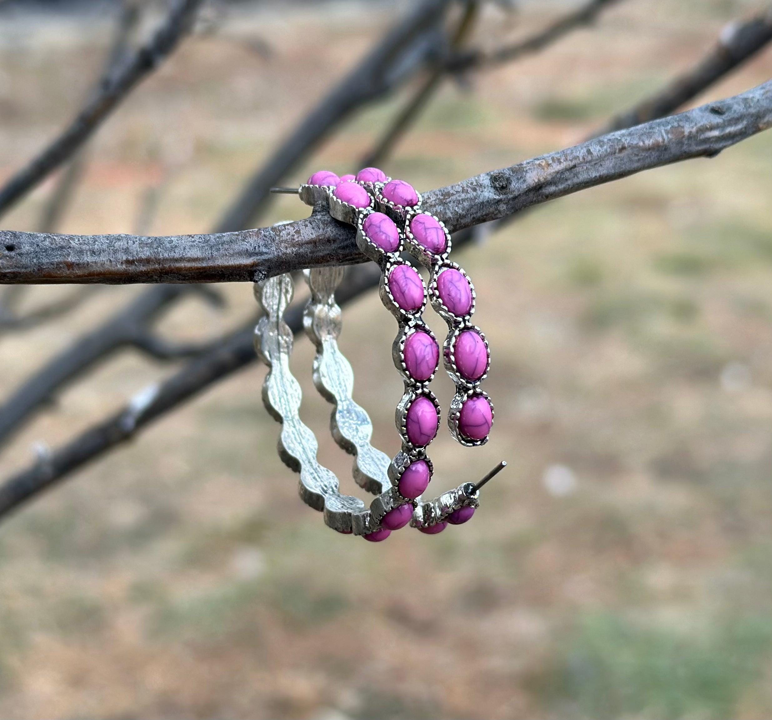 Pink Stone Hoop Earrings 🩷 

Make a bold statement with our Pink Stone Hoop Earrings—the perfect accessory for any cowgirl or Southwestern style lover! 🌟 These large Western earrings are crafted in a stylish C-shape design, featuring vibrant pink gemstones and a burnished silver finish that blends rustic charm with timeless elegance.
These earrings aren’t just accessories—they’re must-have pieces for anyone who loves boho-chic or Western-inspired fashion. FREE Shipping from MONTANA with $35+