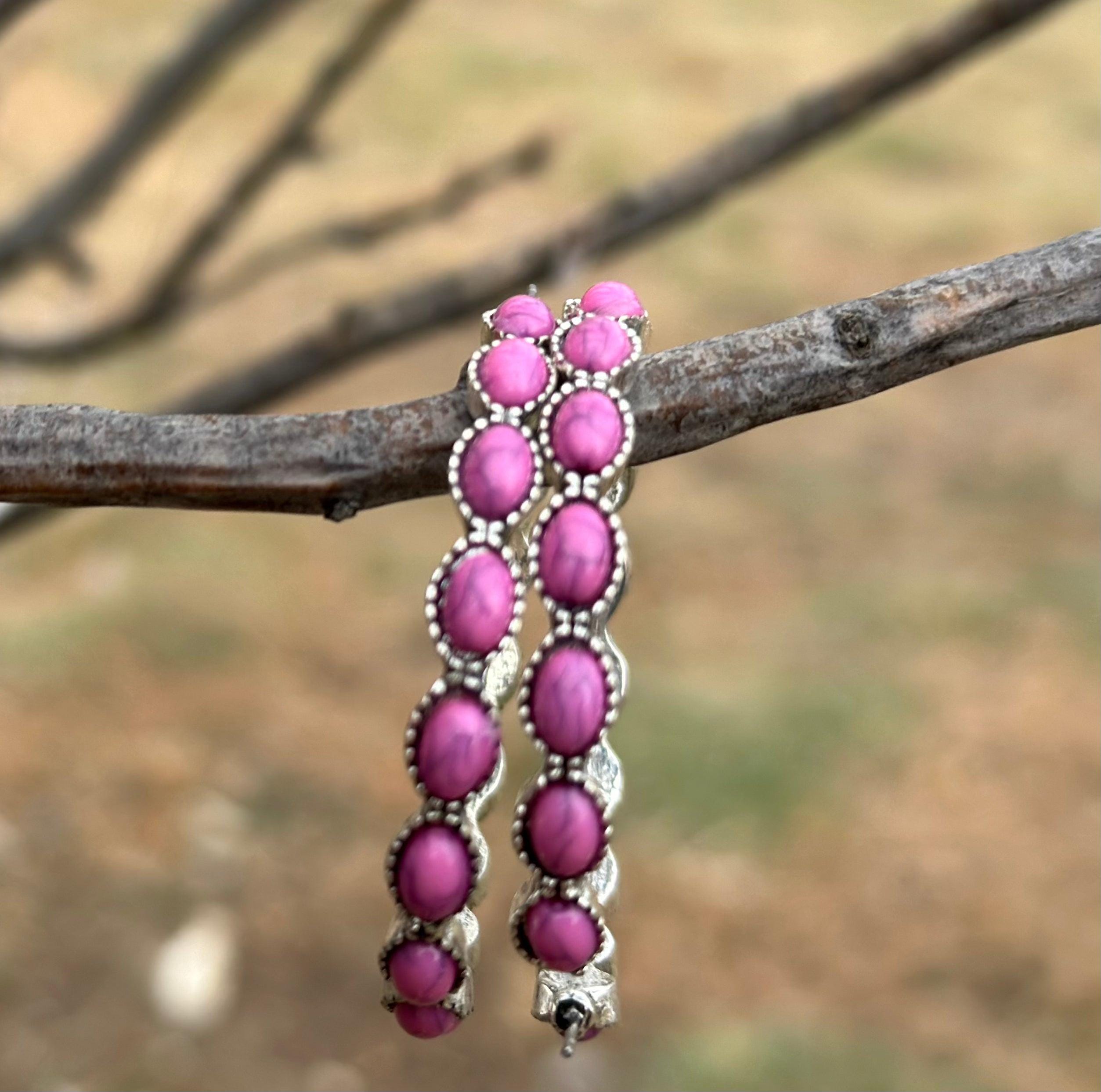 Pink Stone Hoop Earrings 🩷 

Make a bold statement with our Pink Stone Hoop Earrings—the perfect accessory for any cowgirl or Southwestern style lover! 🌟 These large Western earrings are crafted in a stylish C-shape design, featuring vibrant pink gemstones and a burnished silver finish that blends rustic charm with timeless elegance.
These earrings aren’t just accessories—they’re must-have pieces for anyone who loves boho-chic or Western-inspired fashion. FREE Shipping from MONTANA with $35+