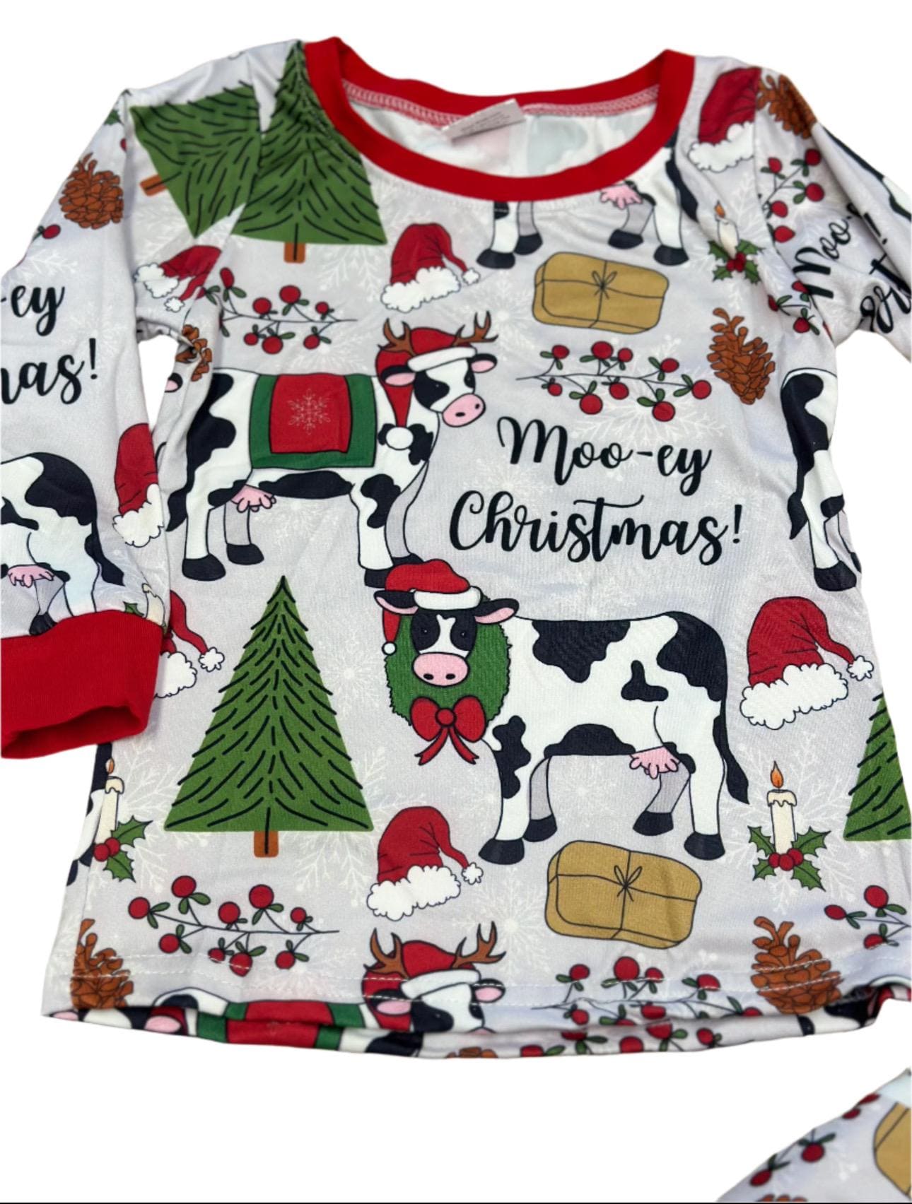 Moo-ey Christmas Pajamas, kids Holstein Cow Christmas pajamas featuring adorable cows wearing Santa Hats, antlers, surrounded by Christmas Trees, pinecones, presents. Farm Kid Pajamas