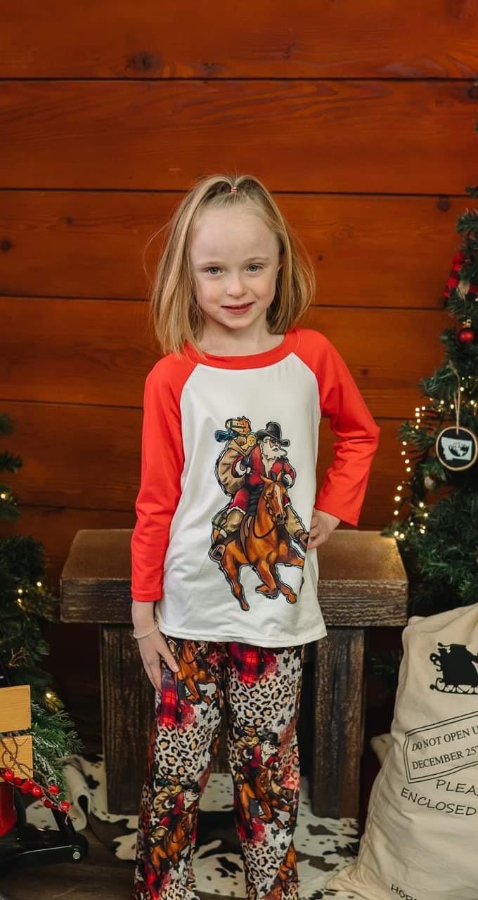 Cowboy Santa Pajamas featuring Santa riding his best horse in a collage of cheetah print, buffalo plaid and Cowboy Christmas spirit! PJ set in 3/6 months baby through adult 3x! Pajamas for EVERYONE!