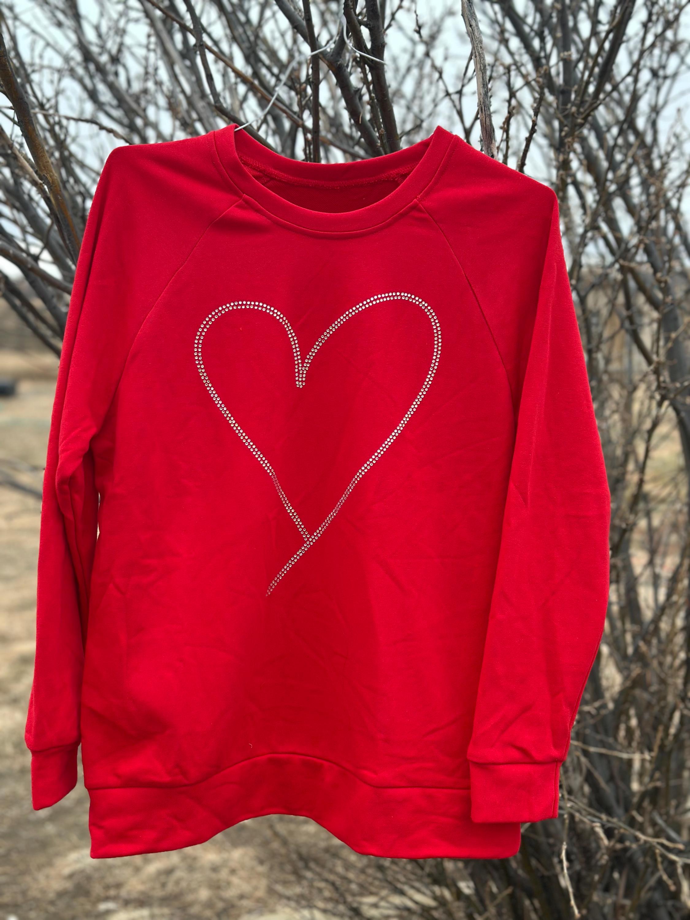 Add sparkle to your style with the Rhinestone Heart Shaped Sweatshirt! Featuring a glittering heart design, relaxed neckline, and cozy long sleeves, it&#39;s perfect for all-day comfort. Ships for FREE—shop Razels now!