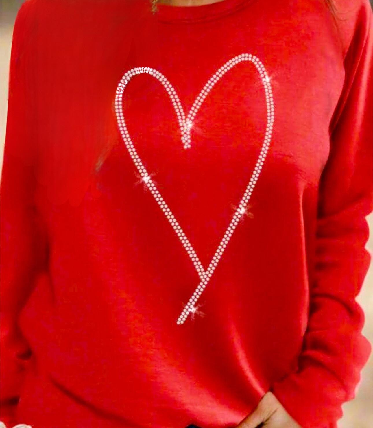 Add sparkle to your style with the Rhinestone Heart Shaped Sweatshirt! Featuring a glittering heart design, relaxed neckline, and cozy long sleeves, it&#39;s perfect for all-day comfort. Ships for FREE—shop Razels now!