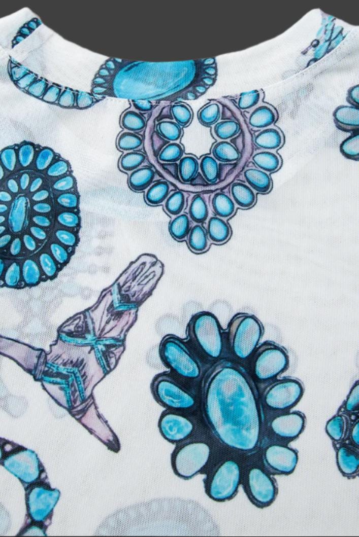 Add a touch of Western flair with this stylish Western Mesh Top! Featuring cow skulls, squash blossoms, and turquoise conchos, this sheer print tee is soft, comfy, and perfect for layering.  Shop Razels—ships FREE with $35+ purchase