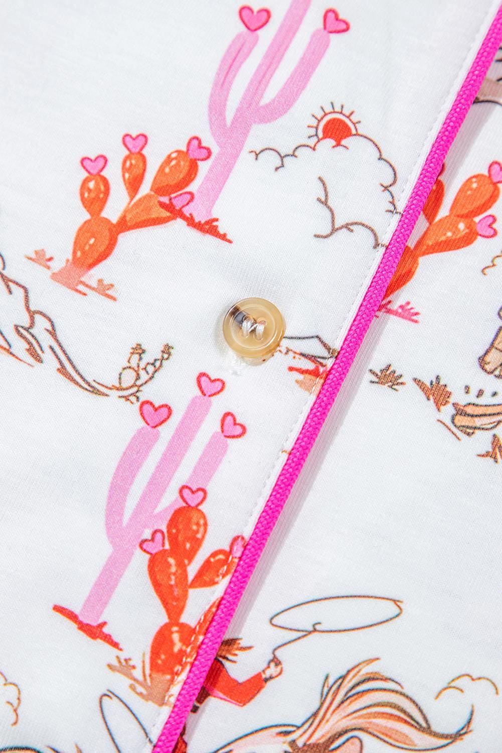 Pink Cowgirl Pajama Short Set 🩷
How fun and cowgirl-tastic is this Cowgirl Pajama Short Set?! This Western Pajama Set is the perfect blend of comfort and style, featuring a button-up top with short sleeves and matching shorts with pockets. Perfect summer cowgirl pajamas for a bridal shower or birthday gift. The playful cowgirl print showcases cowgirls doing their cowgirl thing, with hot pink piping, a drawstring, and pink and orange cacti details. SHIPS FREE from MONTANA today.
