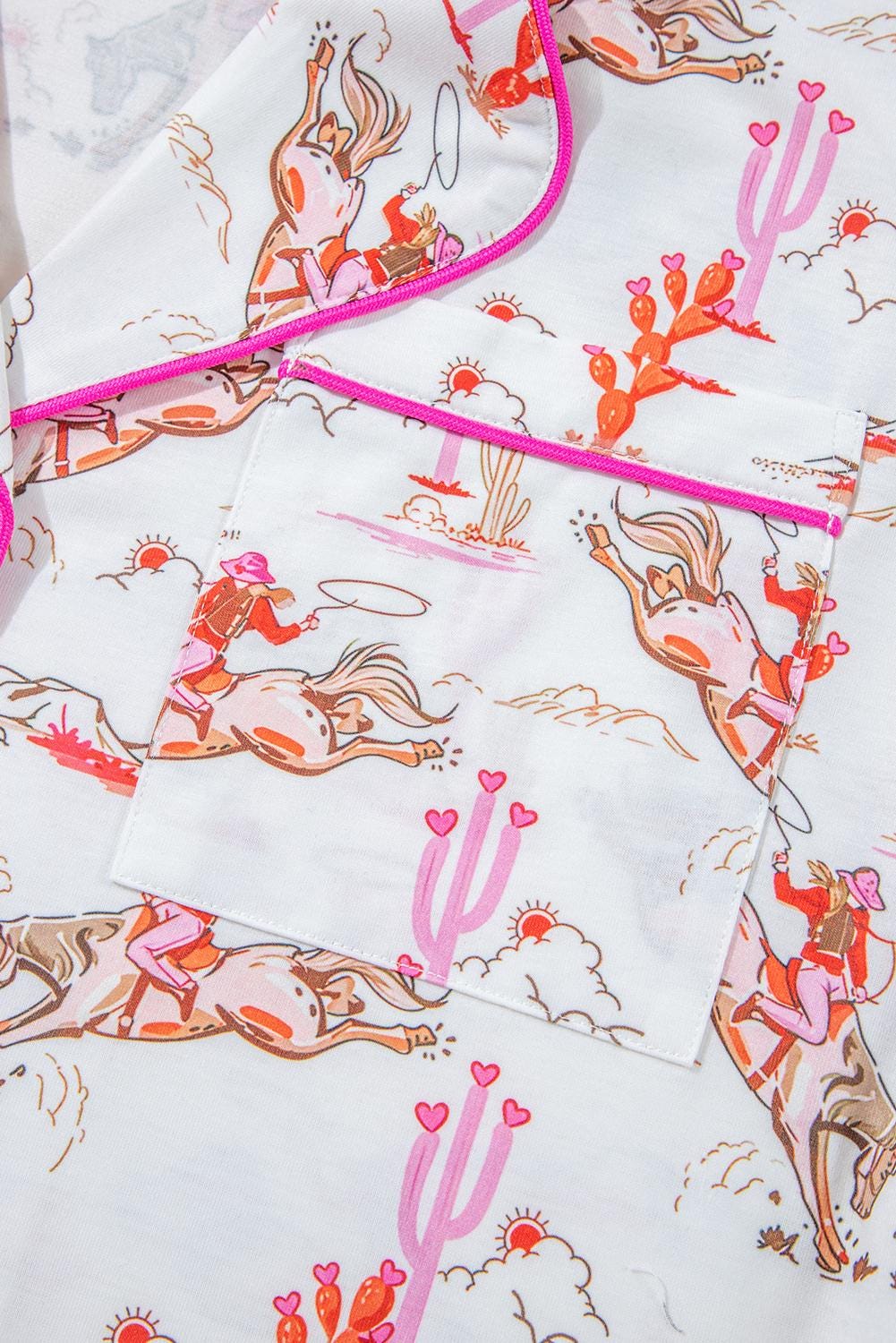 Pink Cowgirl Pajama Set – Fun and stylish with a vibrant cowgirl print, hot pink piping, and pink & orange cacti details. This comfy set features a button-up top and shorts with pockets. Perfect for Valentine’s or birthdays! Ships FREE today @Razels
