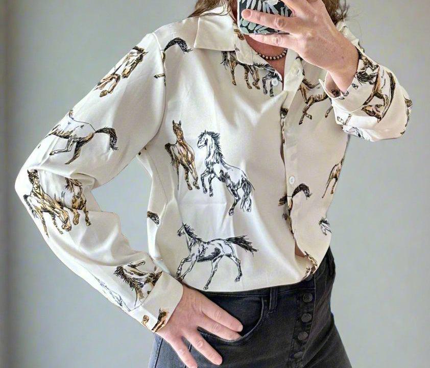 Horse Blouse | Horse Button-Up Shirt | Women&#39;s Western Shirts | HORSE Shirt | Cowgirl Shirt | Wild Horse Shirt
 Unleash Your Inner Cowgirl with the Western Horse Button-Up Shirt! Show off your love for wild horses and Western fashion with this Horse Button-Up Shirt for Women. 
✔️ Striking Wild Horse Print – A beautifully hand-drawn design that brings the spirit of the West to life. Available in black or off-white. SHIPS FREE FROM MONTANA