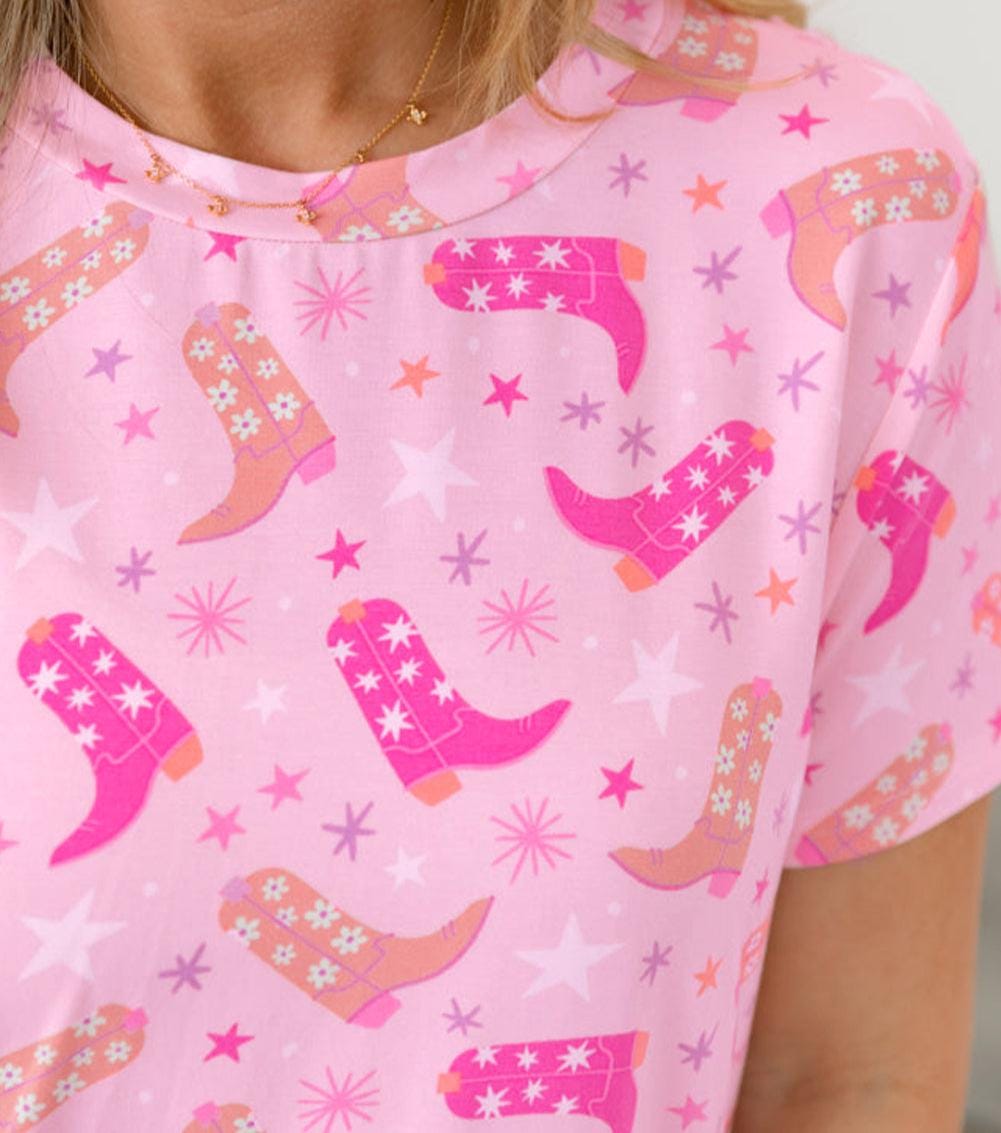 Pink Cowgirl Summer Pajamas | Western Lounge Set | Cowgirl Boot Pajamas 🌵 Cowgirl dreams meet summer comfort! This two-piece pajama set features an allover Western boots print in gorgeous shades of pink, orange, and white, accented by twinkling stars for the ultimate cowgirl vibe. Stylish, breathable, and oh-so-cozy! ✔ Two-Piece Set – Includes t-shirt-style top and matching shorts with pockets and a drawstring waist for the perfect fit. SHIPS FREE from MONTANA TODAY