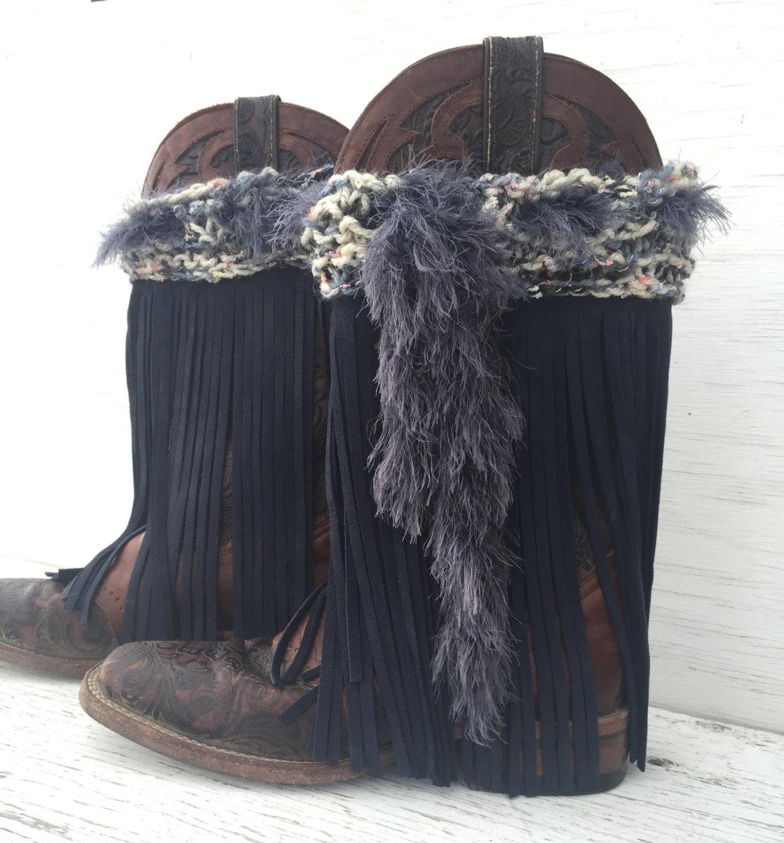 ✨ ONE-OF-A-KIND! ONLY PAIR MADE! ✨
Turn heads with these festival-fabulous Leather Fringe Boot Covers! Hand-knit, hand-fringed, and totally unique, they’re the perfect statement piece for festivals, western wear, or everyday boho vibes.
✔ Hand-knit top in a dreamy mix of cream, blue, grey & black, with hints of pastel that look like tiny flowers! 🌸
✔ Dark blue leather fringe for a bold, stylish accent
✔ Hand-knit ‘fur’ boa drawstring 
✔ Adjustable fit to work with all your favorite boots
