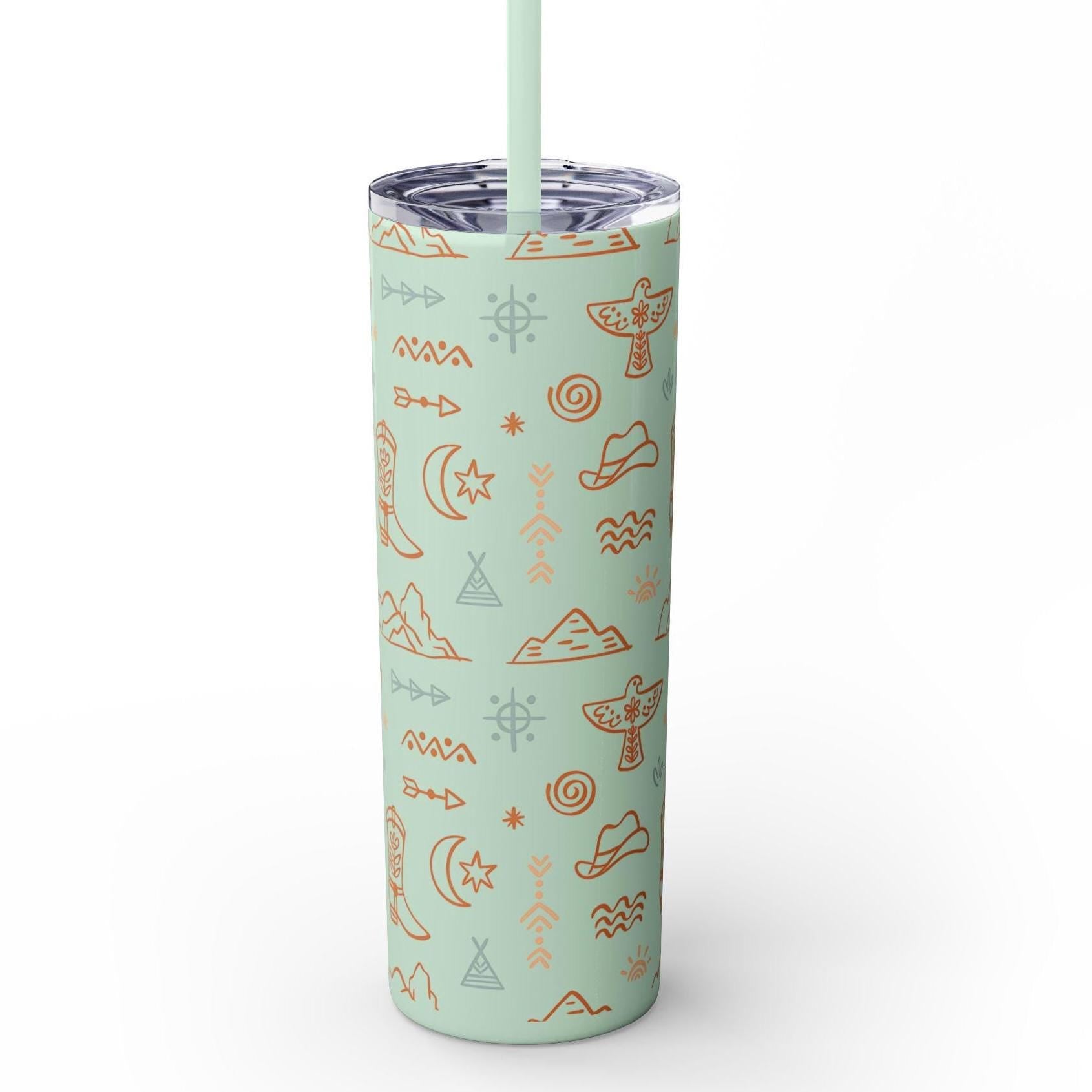 WESTERN SKINNY TUMBLER, COWBOY TUMBLER, COWGIRL TUMBLER FEATURING: allover boho western print featuring thunderbirds, mountains, cowboy hats, boots, and other iconic Western symbols. Double-wall insulation  Available in 8 stunning colors, including glitter options  Includes a clear plastic lid with a color-matching straw ✅ Made from durable, non-toxic stainless steel and BPA-free plastic. ✅ Slim, tapered design fit SHIPS FREE W/ $35+ PURCHASE