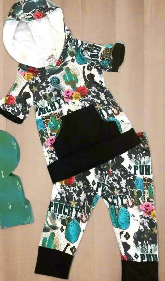 Girls Cowgirl Outfit | Western Hoodie Jogger Set for Kids  This Girls PUNCHY Cowgirl Outfit is full of retro cowboy vibes. This Western outfit features an allover Western print with matching jogger pants and a lightweight, short-sleeved hoodie top.