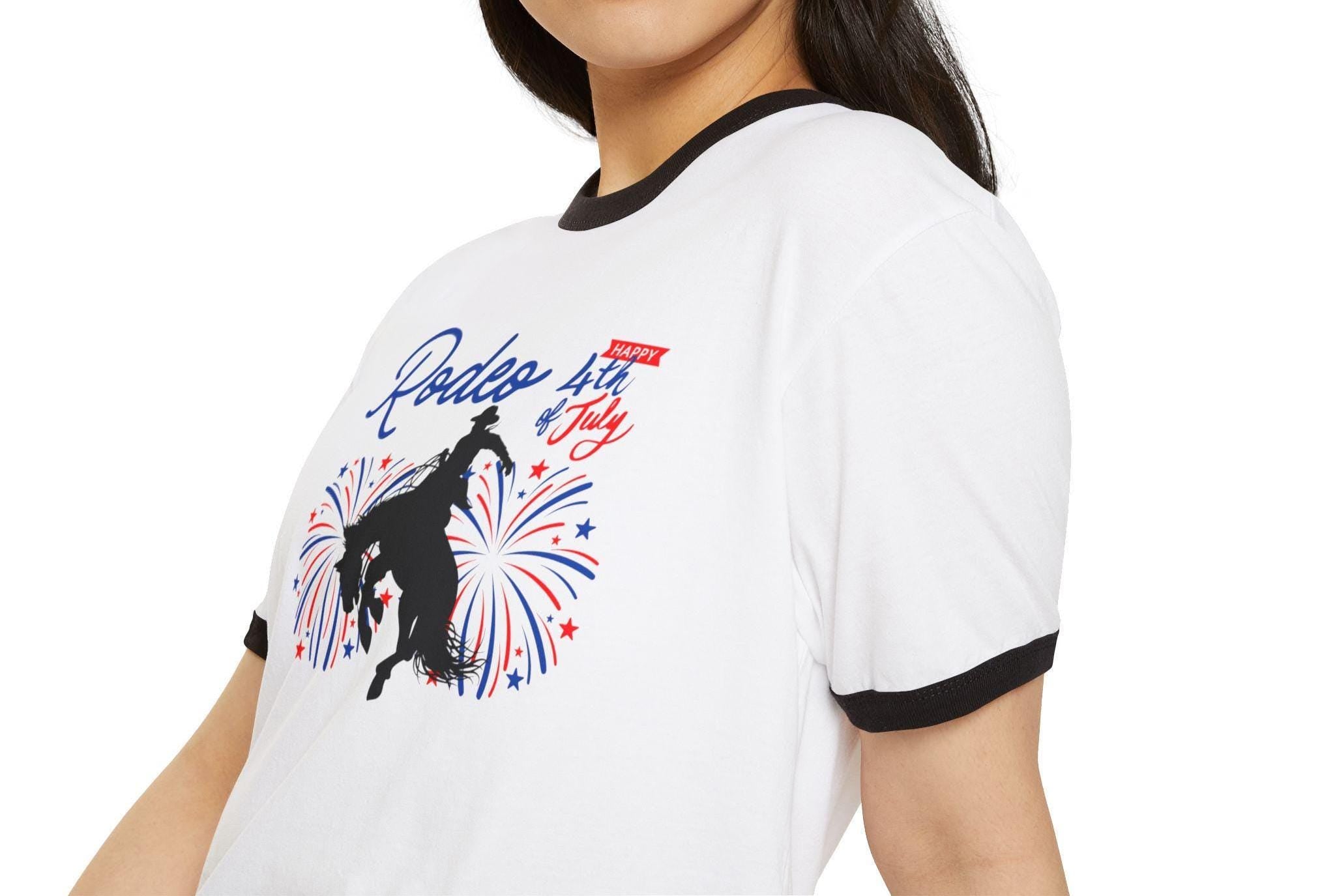 This classic ringer tee brings serious rodeo energy to your Independence Day look. Featuring a cowboy bronc silhouette lit up by red, white, and blue fireworks, plus bold RODEO and Happy 4th of July text—it’s loud, proud, and made for the kind of summer day that ends with fireworks and dust in your boots.

✓ 100% combed, ring-spun cotton – soft + breathable
✓ Contrasting baby rib collar & sleeve trim