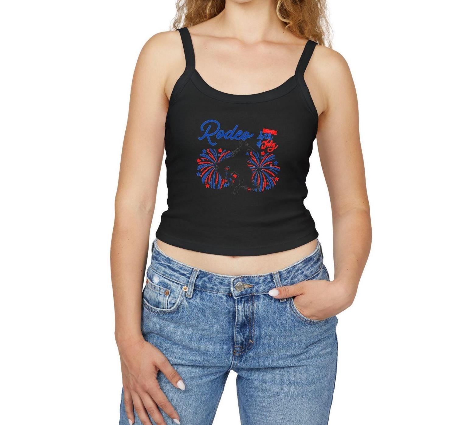Rodeo Crop Tank – Bronc Rider & Fireworks for the 4th of July
Celebrate Independence Day with a little rodeo flair! This cropped spaghetti strap tank features our bold bronc rider silhouette bursting through red, white, and blue fireworks—perfect for cowgirls who love freedom, fashion, and a little yeehaw energy 🤠🎆

Made from a buttery-soft cotton blend with supportive thick straps, it’s made for sunny parades, backyard BBQs, or dancing under fireworks.