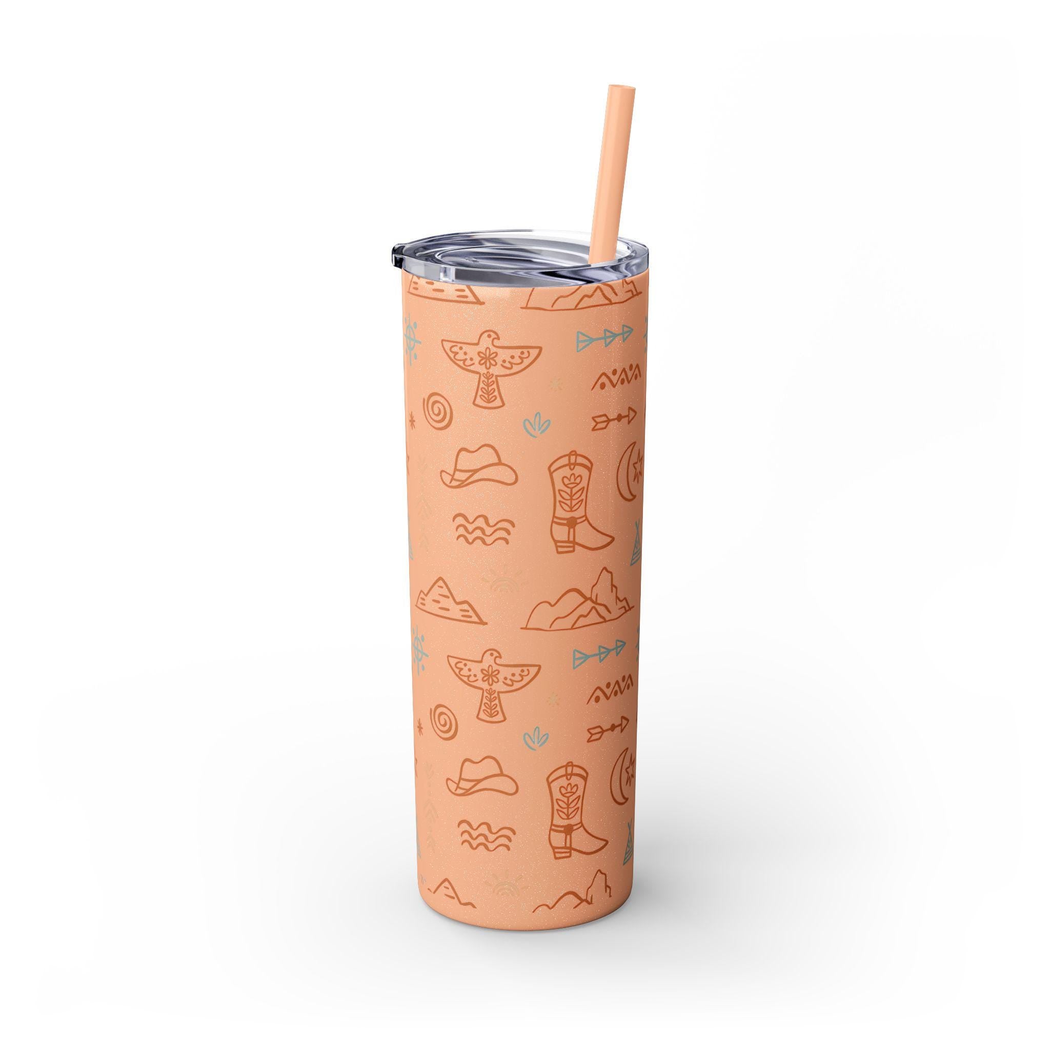 WESTERN SKINNY TUMBLER, COWBOY TUMBLER, COWGIRL TUMBLER FEATURING: allover boho western print featuring thunderbirds, mountains, cowboy hats, boots, and other iconic Western symbols. Double-wall insulation  Available in 8 stunning colors, including glitter options  Includes a clear plastic lid with a color-matching straw ✅ Made from durable, non-toxic stainless steel and BPA-free plastic. ✅ Slim, tapered design fit SHIPS FREE W/ $35+ PURCHASE