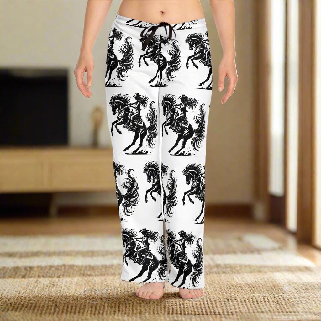 Wild Cowgirl Pajama Pants – Bold Western Lounge Vibes
Perfect for bachelorette parties, horse lovers, or any cowgirl who rides bold—even in her dreams. Wear them as pajamas, loungewear, or throw on a hoodie and boots.
100% polyester jersey knit – soft, lightweight, and made to move
Relaxed comfort fit with a flowy silhouette
✅ Bold all-over cowgirl & horse print – black on crisp white
 Back elastic waistband + black drawstring for a custom fit
 Tagless comfort with a sewn-in care label