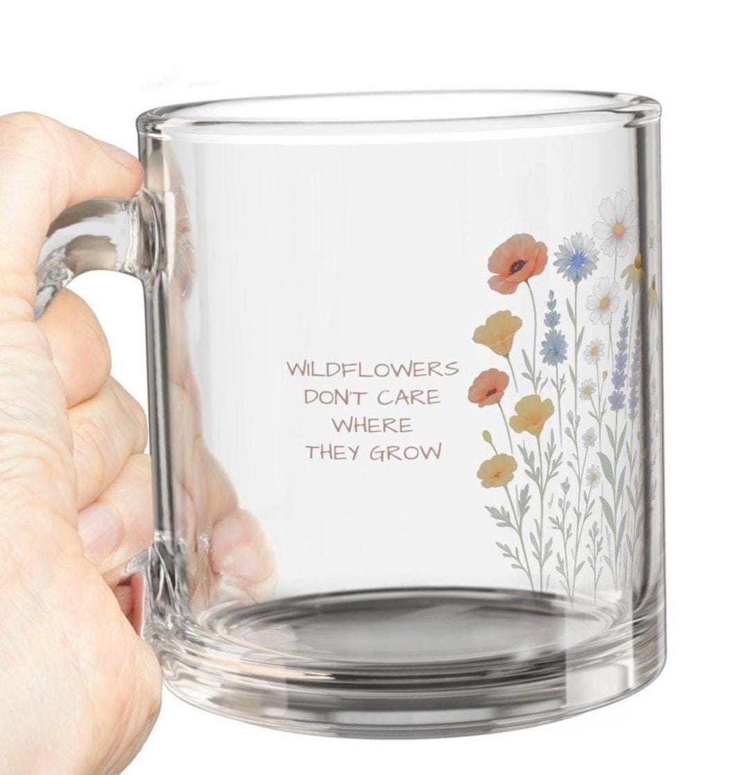 Wildflower Personalized Glass Mug – 10oz Floral Tea & Coffee Cup 🌸  “Wildflowers don’t care where they grow” — and neither do your cozy moments. 🌿  Features: ✓ Clear, durable glass with an elegant floral design ✓ Comfortable ergonomic handle for easy sipping ✓ Holds 10oz – ideal for tea, coffee, or cozy drinks ✓ Heat-resistant (but not microwave-safe!) ✓ A lovely gift for birthdays, holidays, or just because