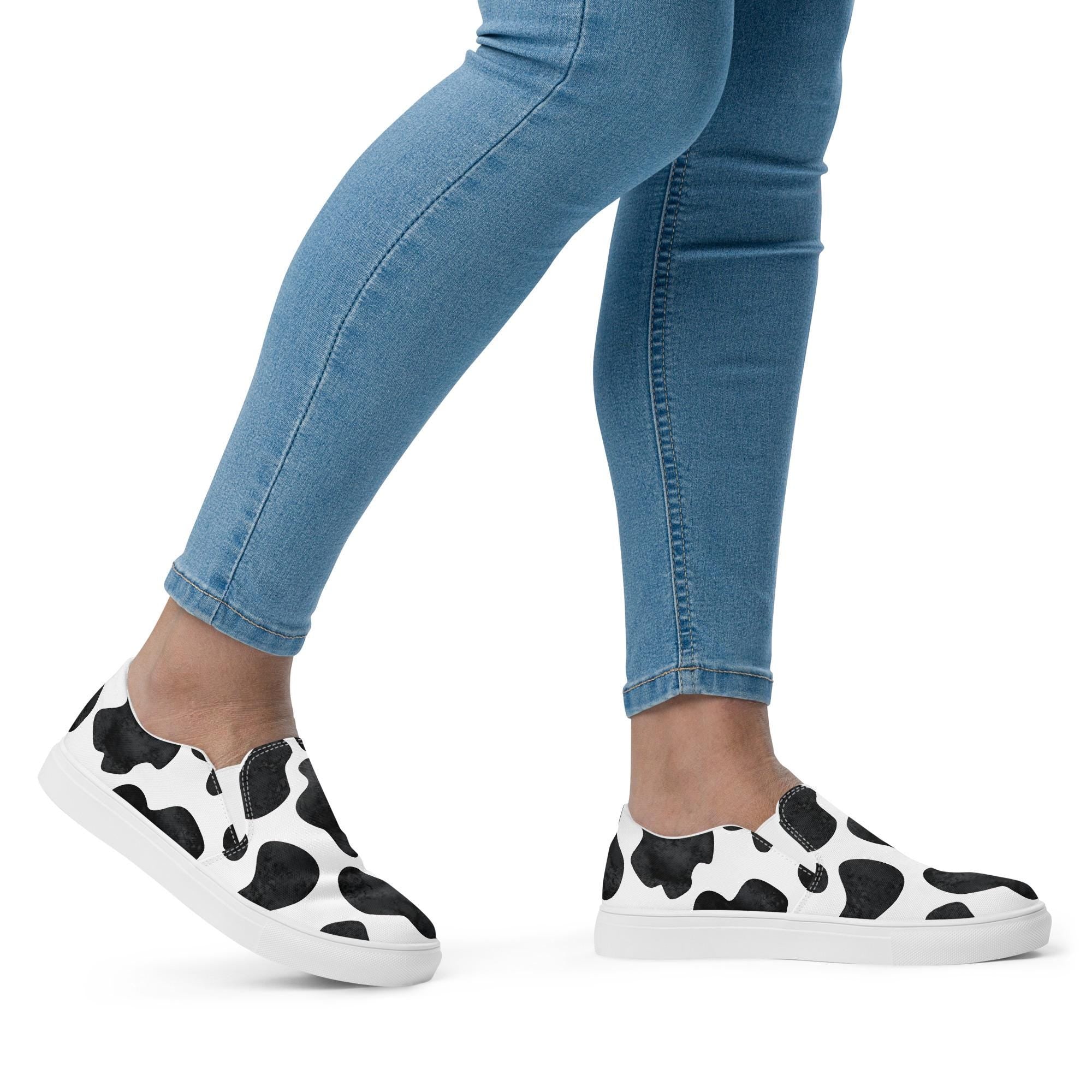 Cowprint Women’s Slip-On Shoes | Black & White Western Canvas Kicks  These black and white slip-on canvas shoes are the perfect blend of bold Western vibes and all-day comfort. Whether you&#39;re pairing them with denim cutoffs or your favorite dress, they&#39;re ready to moooove with you. ✓ Elastic side accents for easy on/off
✓ Breathable lining + soft removable insole
✓ Padded collar and tongue for added comfort
✓ Razels branding on the box, tongue & insole
✓ Printed, cut & handmade with care